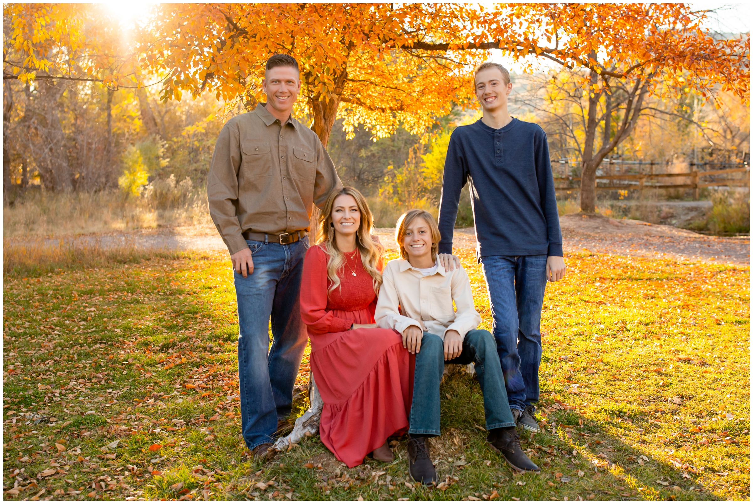 family sitting on large rock during fall family pictures at Bohn Park in Lyons Colorado