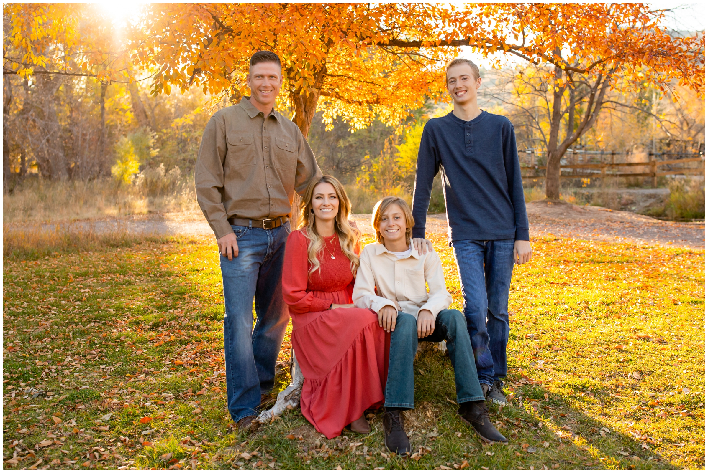 family sitting on large rock during fall family pictures at Bohn Park in Lyons Colorado 