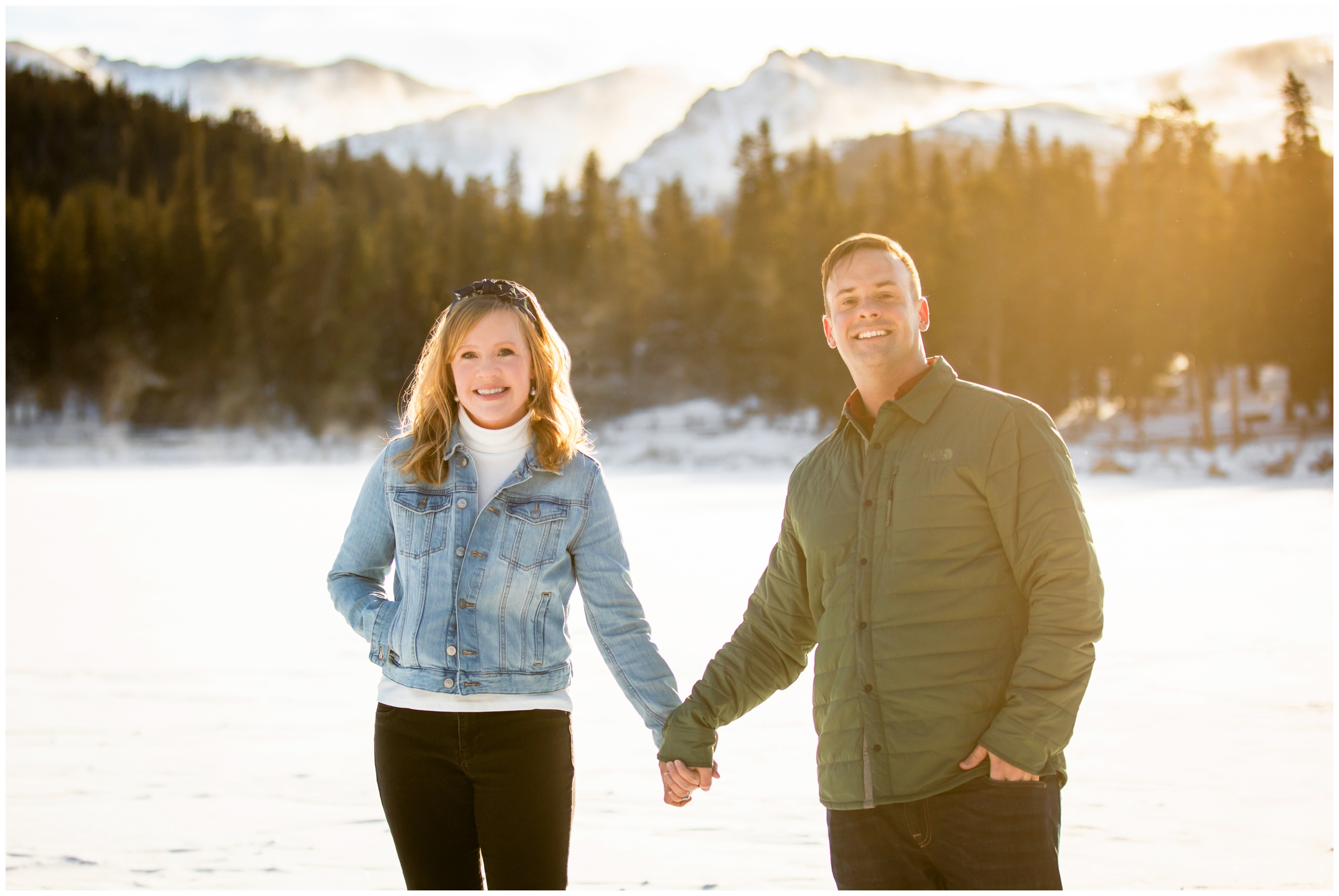 couple holding hands on frozen lake during Echo Lake Colorado mountain couples photography session