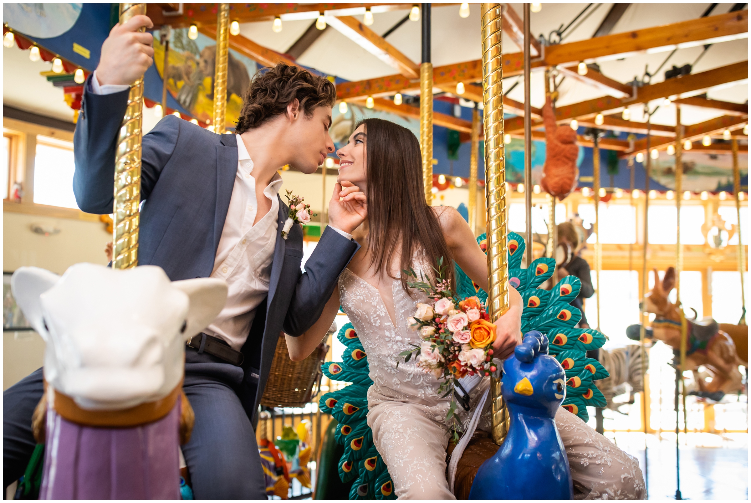 couple riding on carousel of happiness during unique Colorado elopement wedding portraits in Nederland