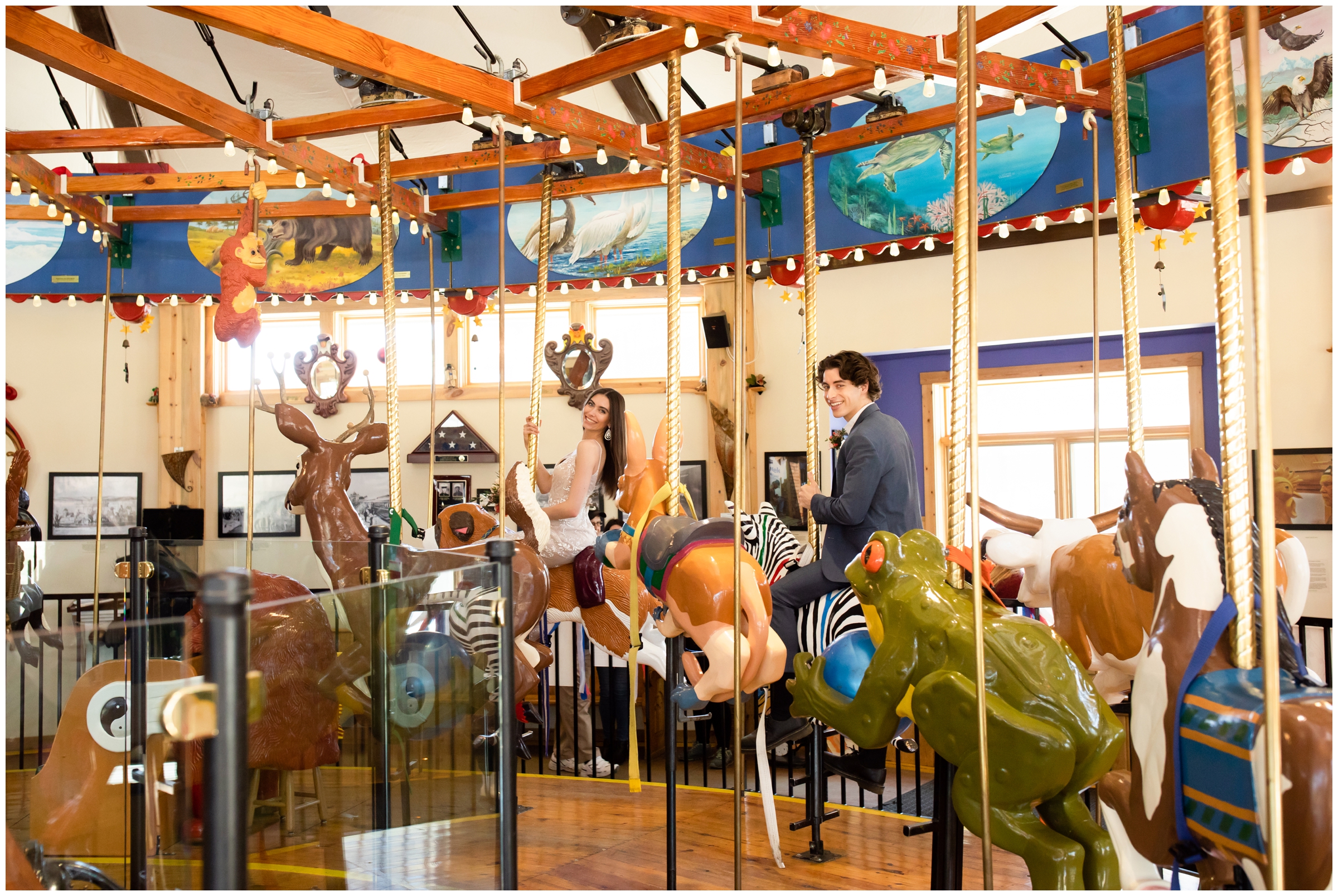 couple riding on carousel during carnival engagement pictures in Colorado 