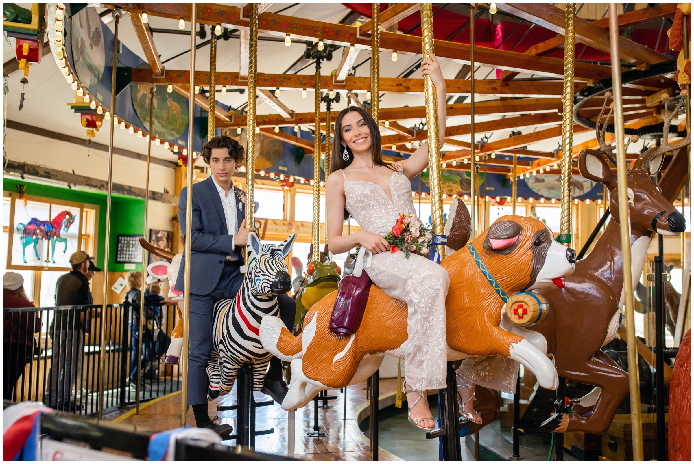 couple riding on carousel during Nederland Colorado creative unique wedding elopement at a carousel