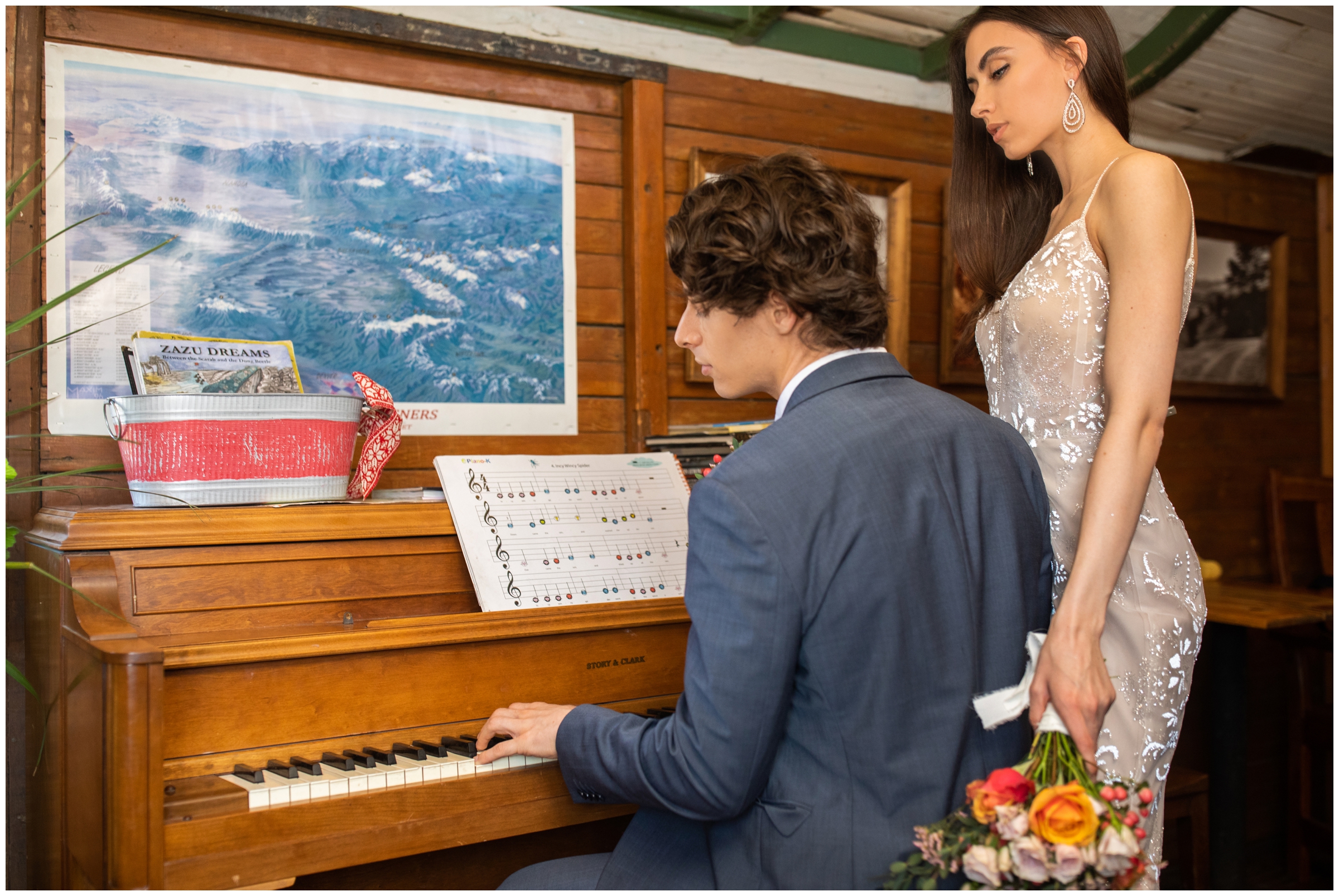groom playing piano for his bride at the Train Cars Coffee in Nederland CO