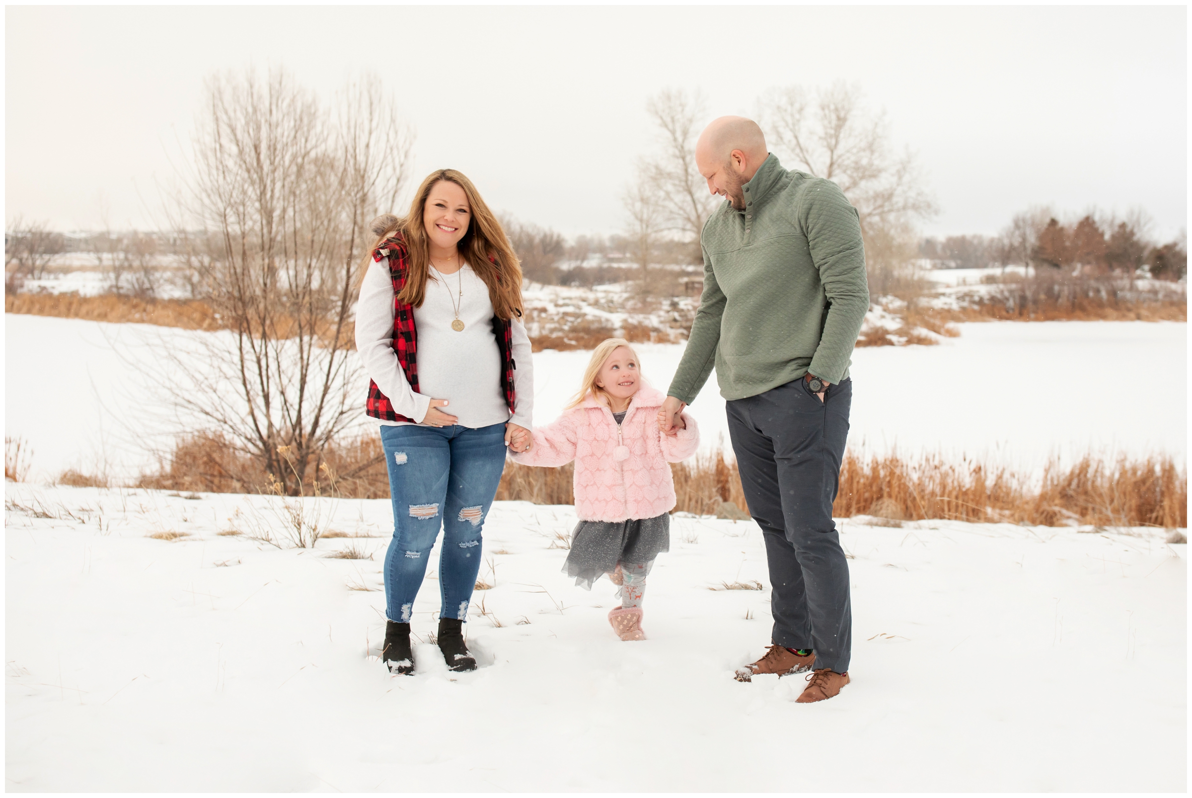 family posing in the snow at Sandstone Ranch during Longmont Colorado maternity family photography session