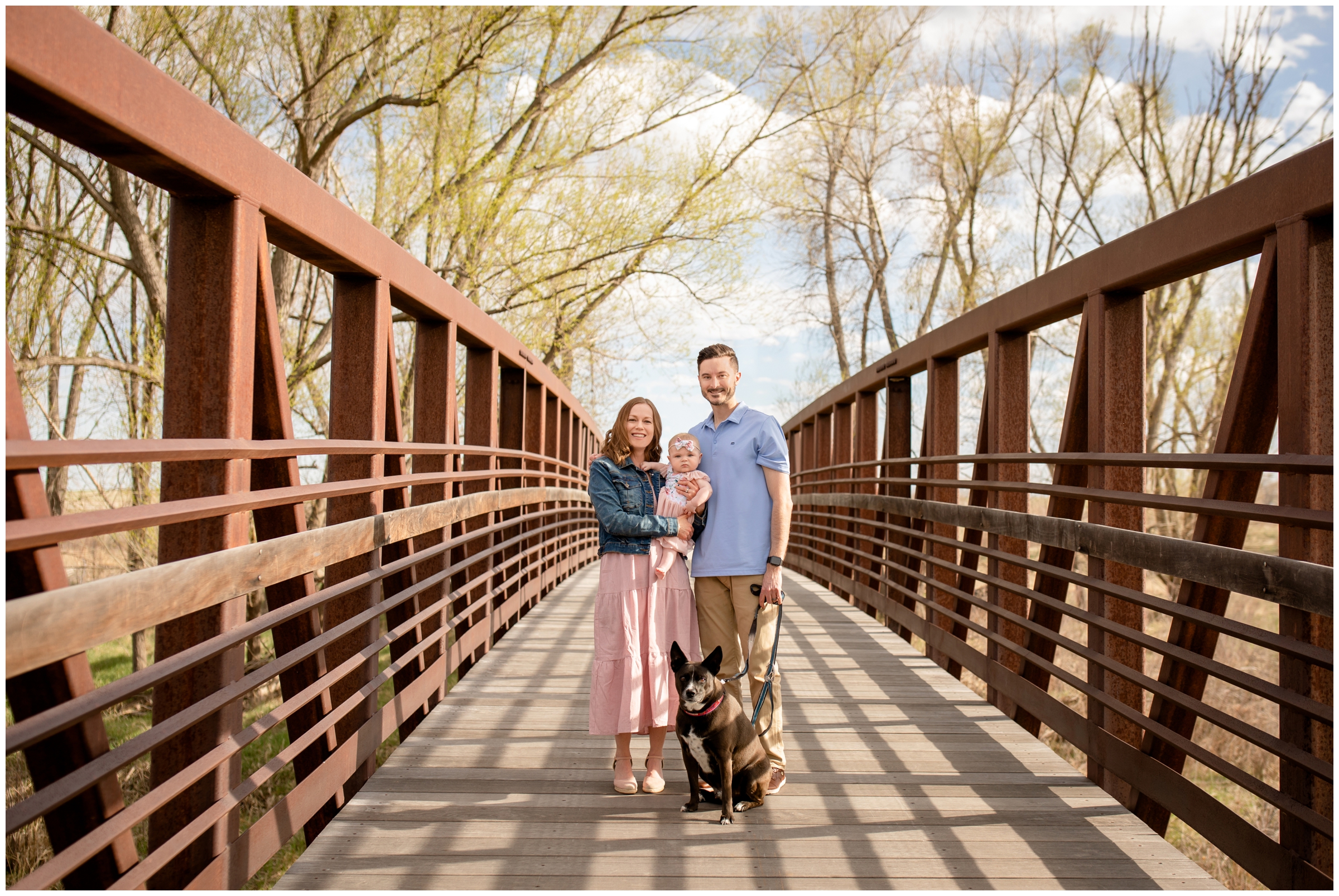 family posing on bridge at sandstone ranch visitor's center