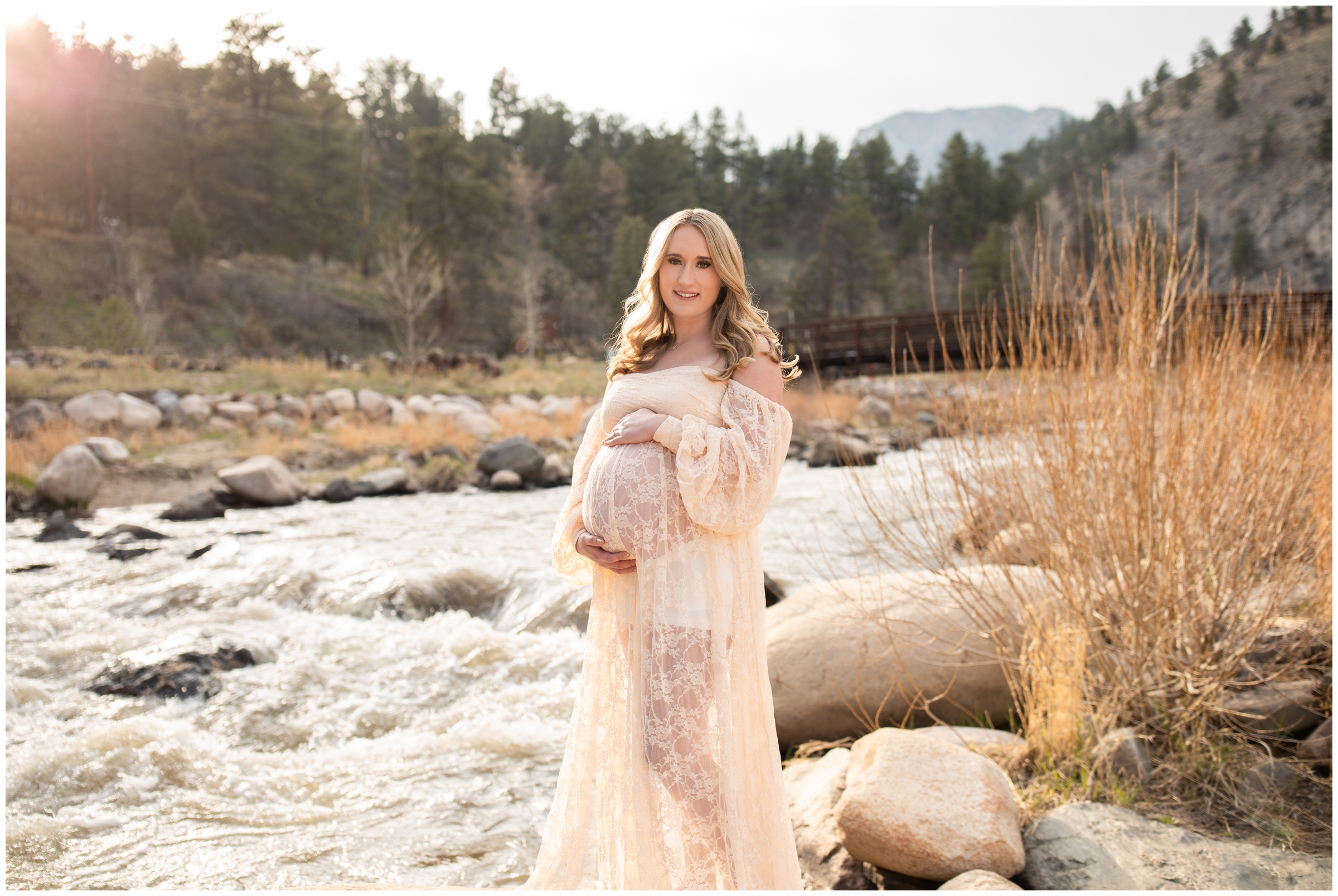 couple posing in front of mountain river during Loveland Colorado maternity photography session 