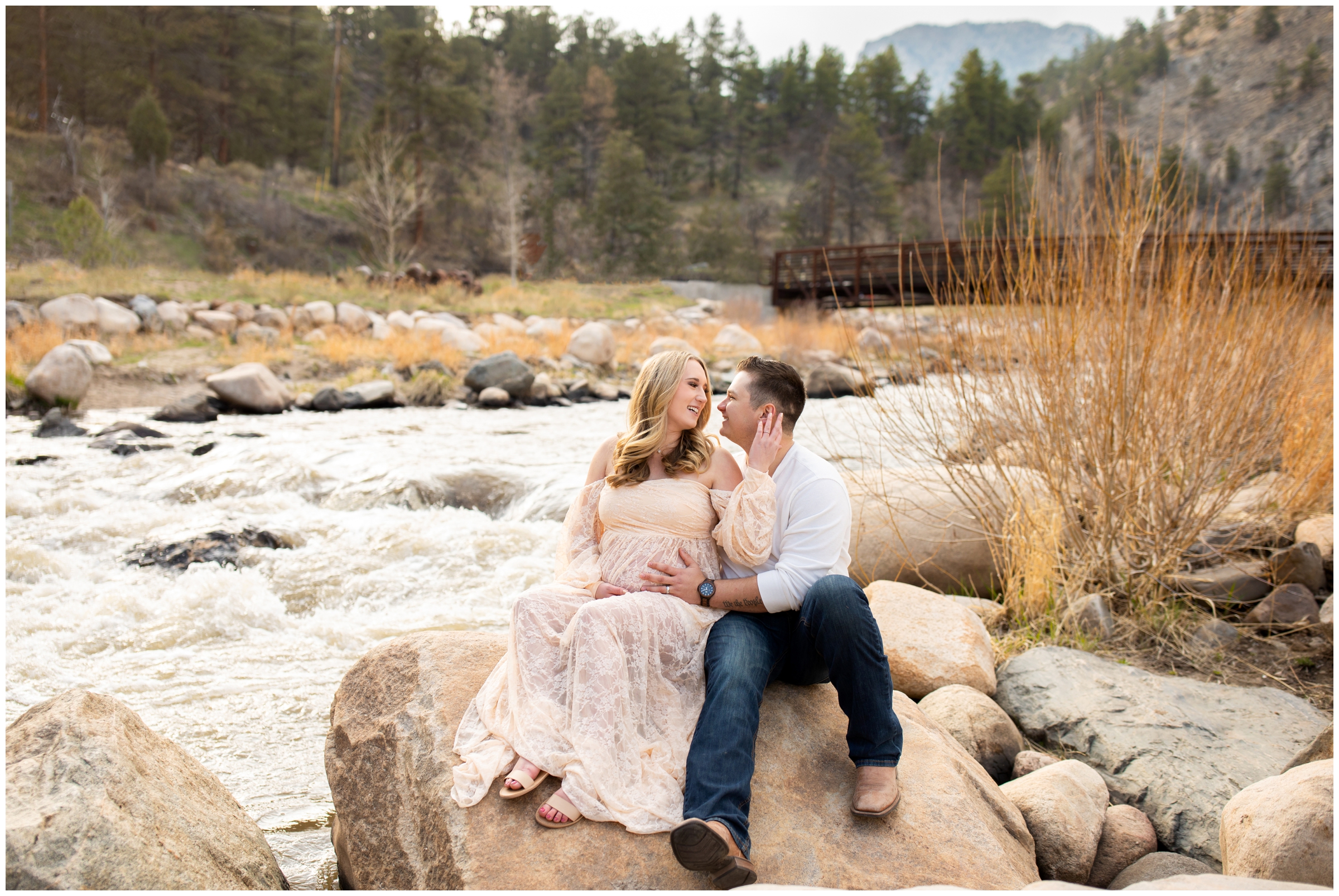 couple posing along the Big Thompson River during spring maternity portraits in the Colorado mountains 