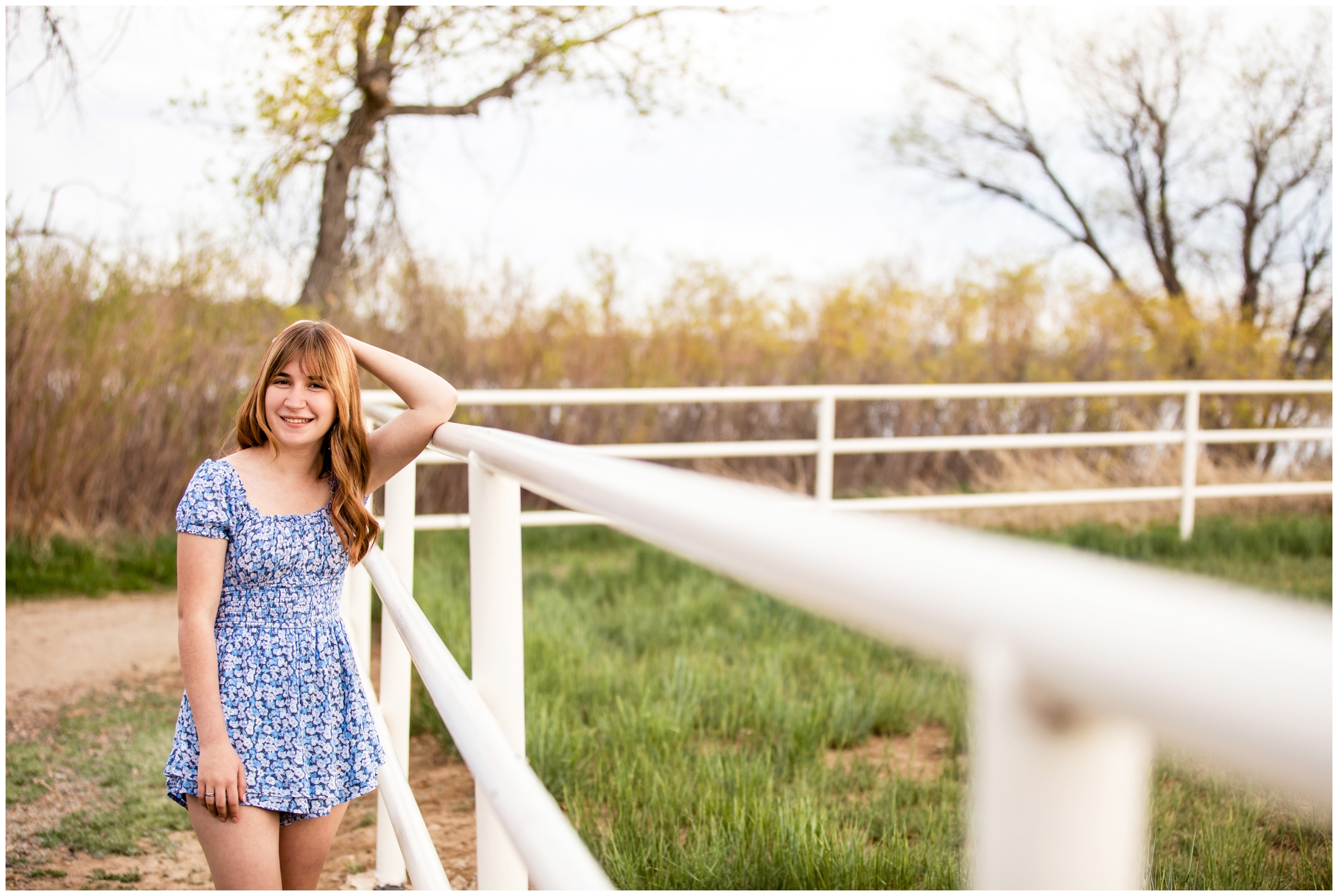 teen leaning against fence during Westminster senior portraits at McKay Lake by Colorado photographer Plum Pretty Photography