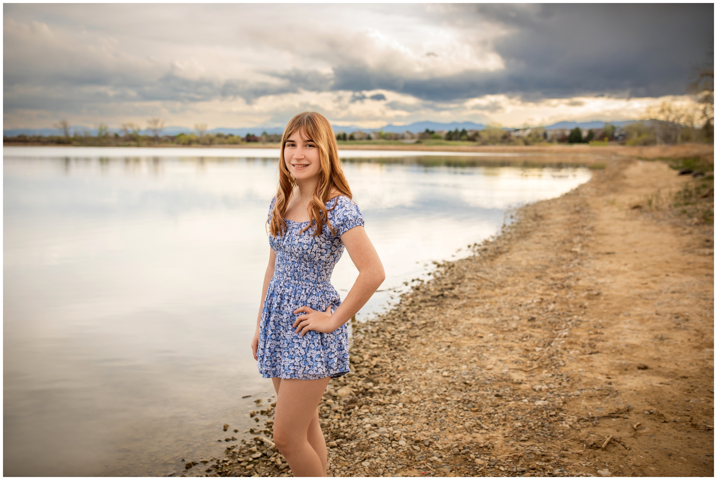 teen posing in front of lake during Colorado sunset senior pictures at McKay Lake