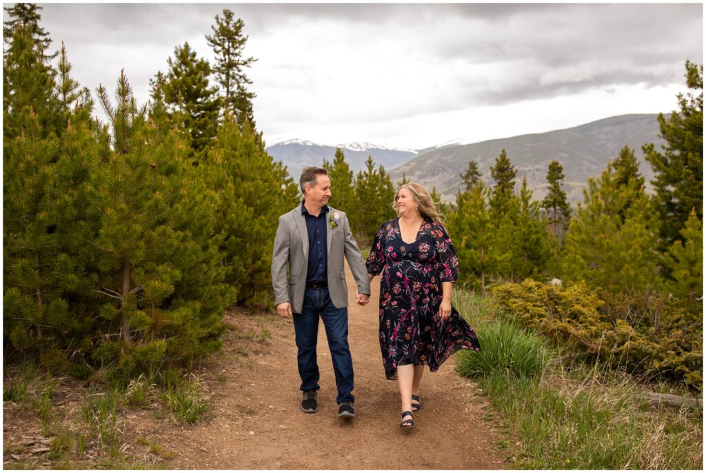 couple walking on dirt trail during Breckenridge mountain elopement pictures at Sapphire Point by Colorado wedding photographer Plum Pretty Photography