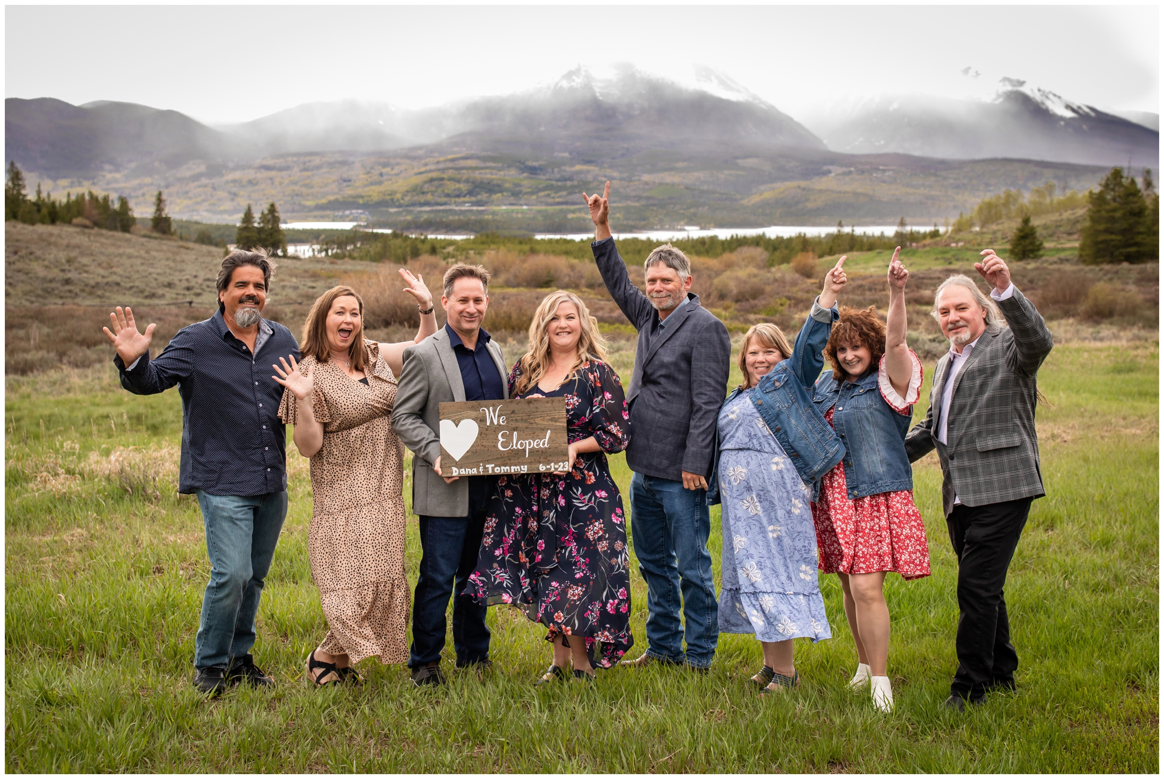 couple with their friends cheering in a field at windy point campground during Breckenridge spring elopement 