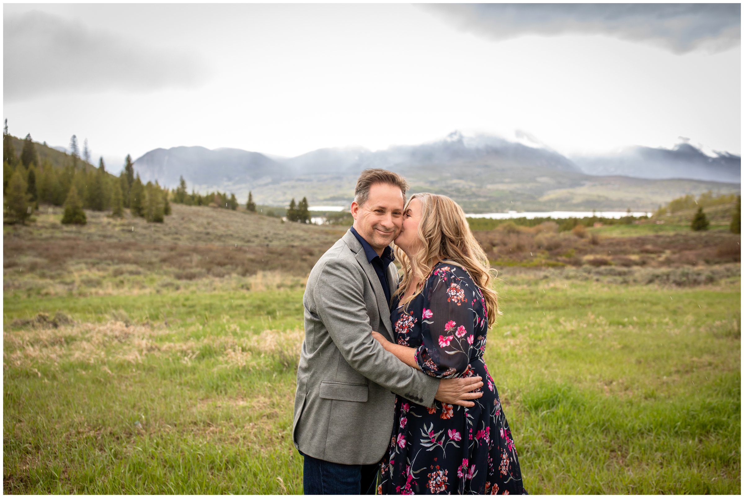 woman kissing husband on cheek in a field at Windy Point Campground during Breckenridge Colorado elopement wedding 