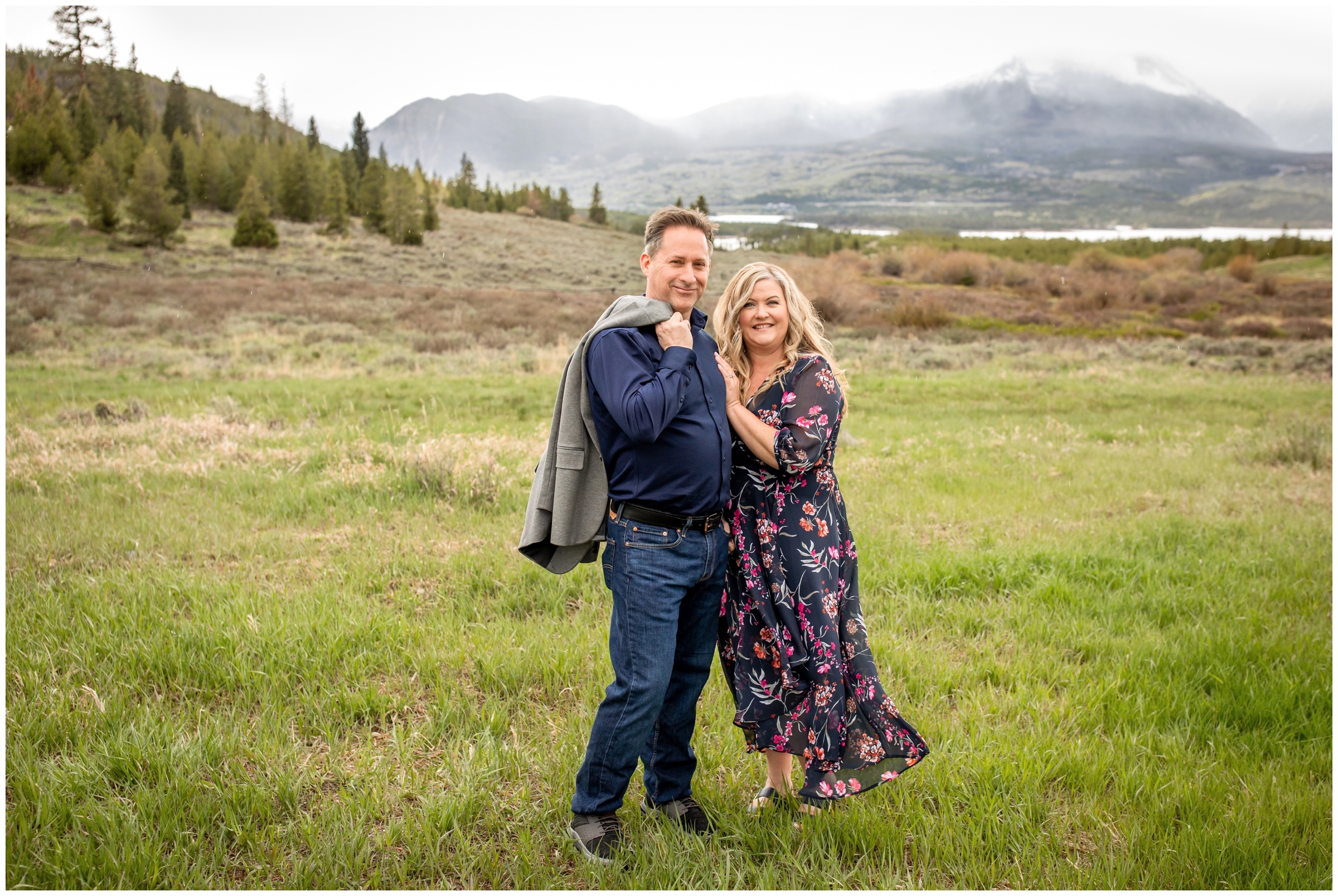 couple posing in a field during rainy Colorado elopement wedding portraits at Sapphire Point