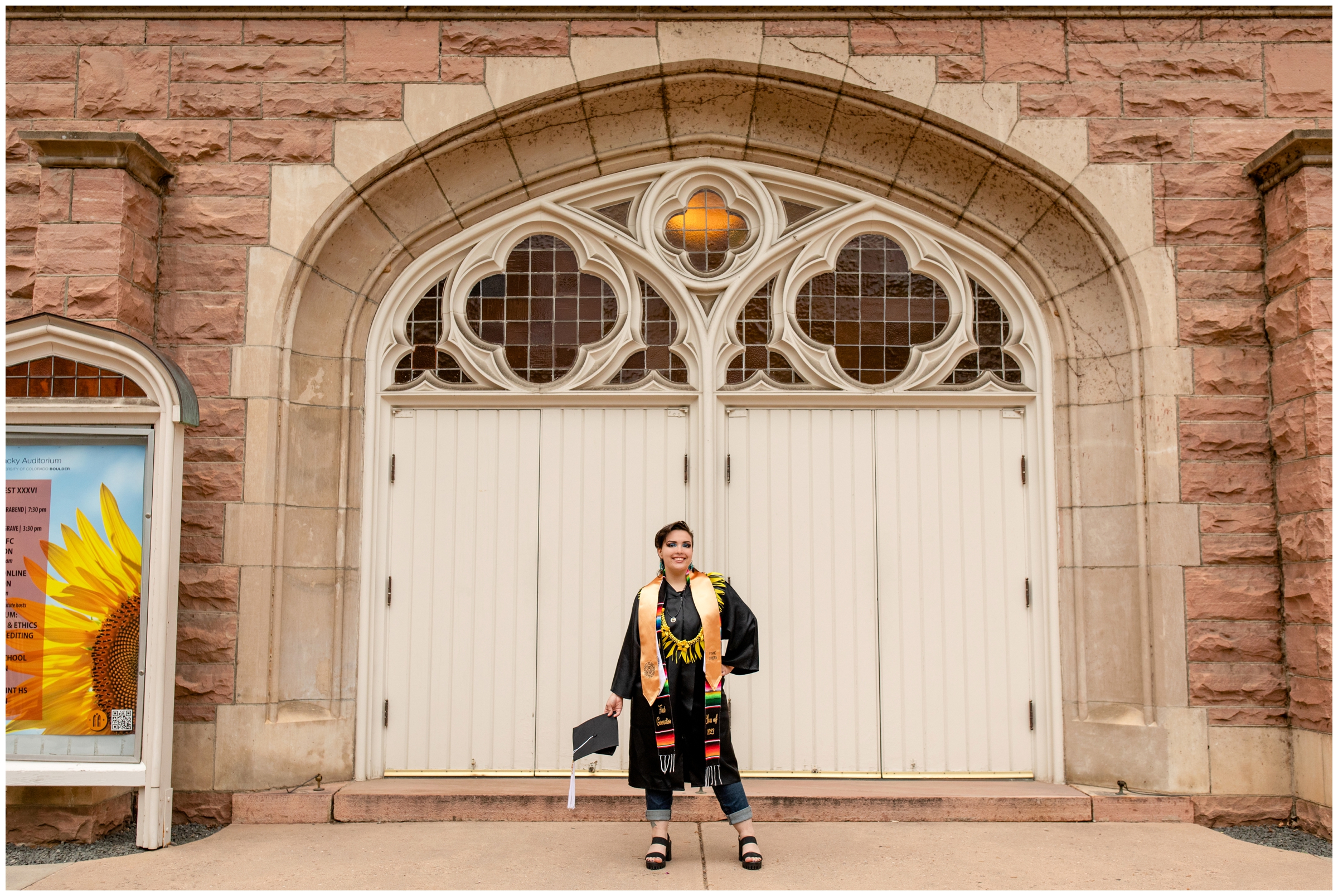 woman posing in front of ornate doors at Macky Auditorium during college graduation pictures at CU Boulder