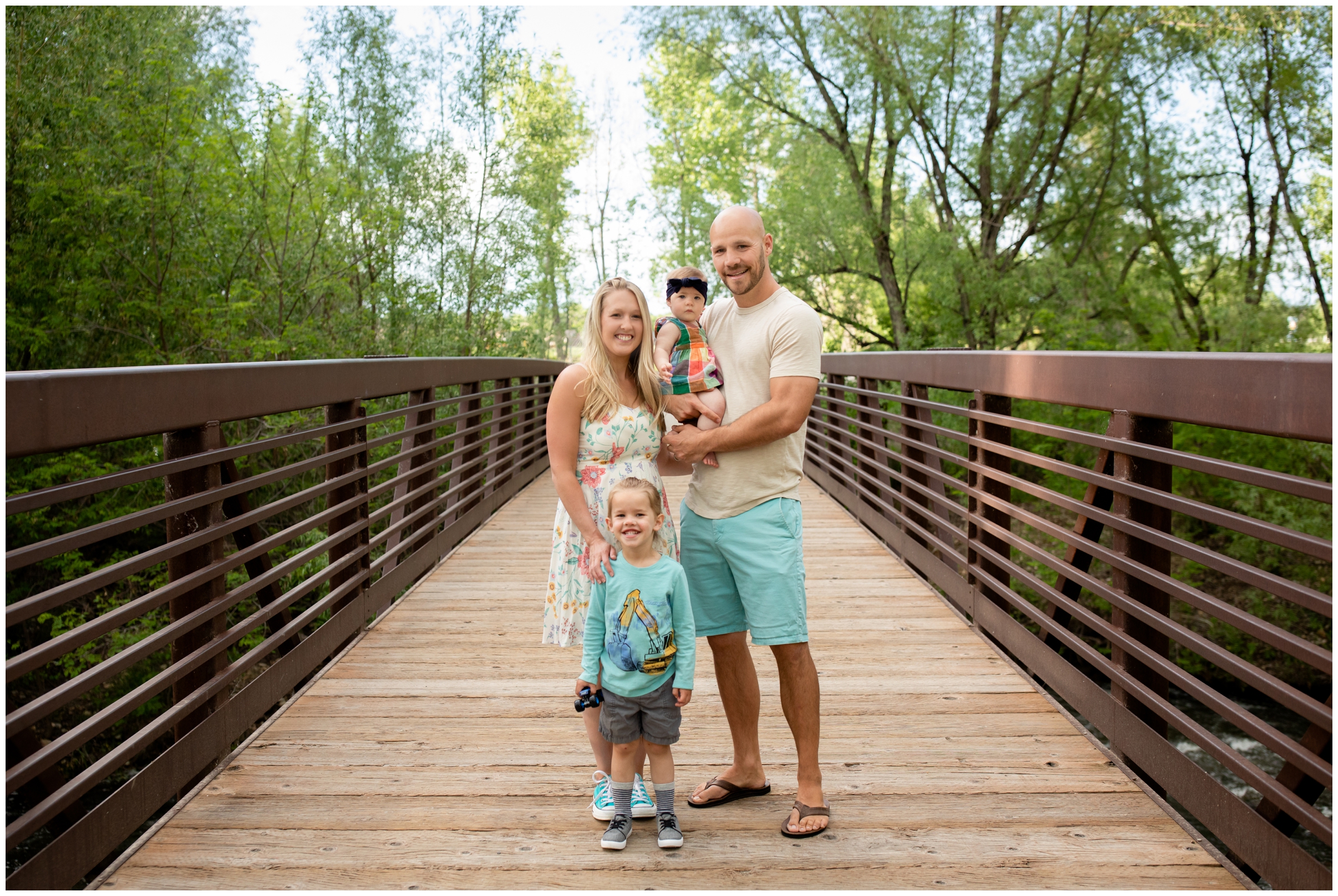 family posing on wooden bridge at Golden Ponds during Longmont family photography session 