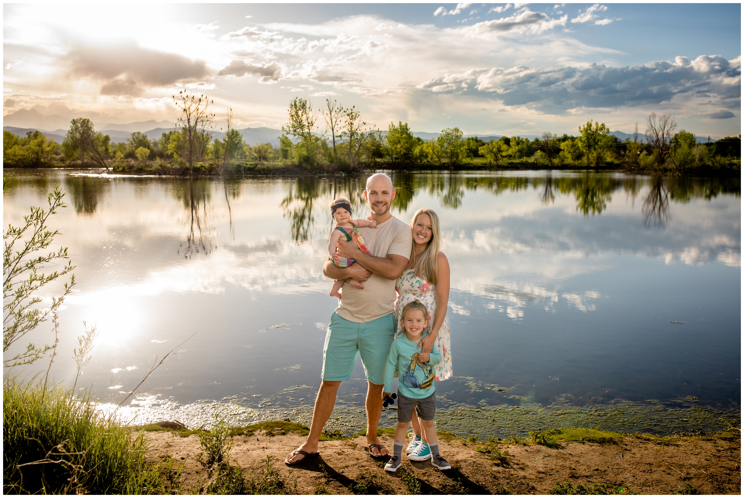 family posing in front of mountain lake at Golden Ponds in Longmont during Colorado portrait photography session