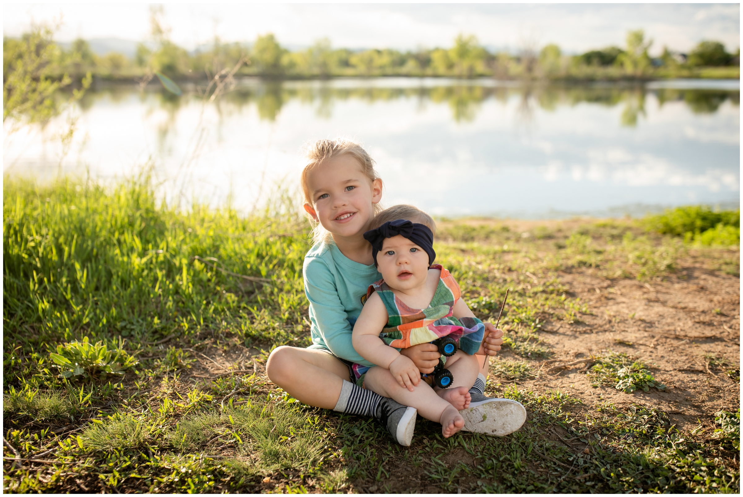 little boy holding baby sister at Golden Ponds during Longmont Colorado family pictures 