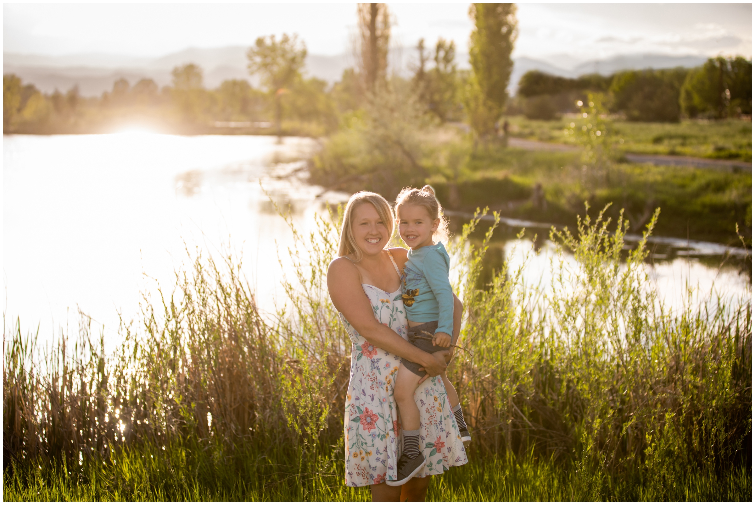 mom holding sun during sunny golden hour at Longmont Colorado family photography session 