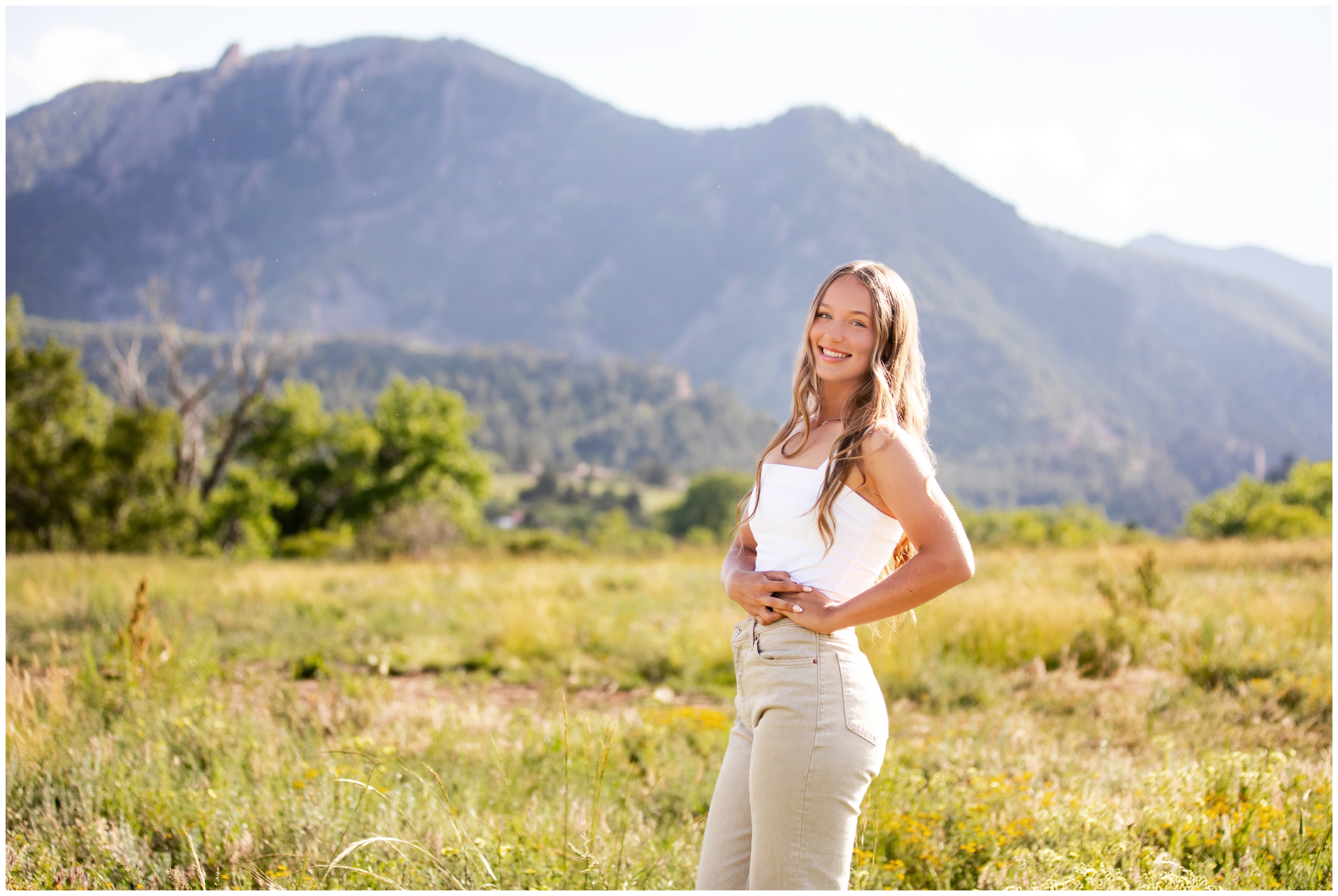 teen posing in a field at South Mesa Trail during Colorado mountain senior pictures in Boulder 