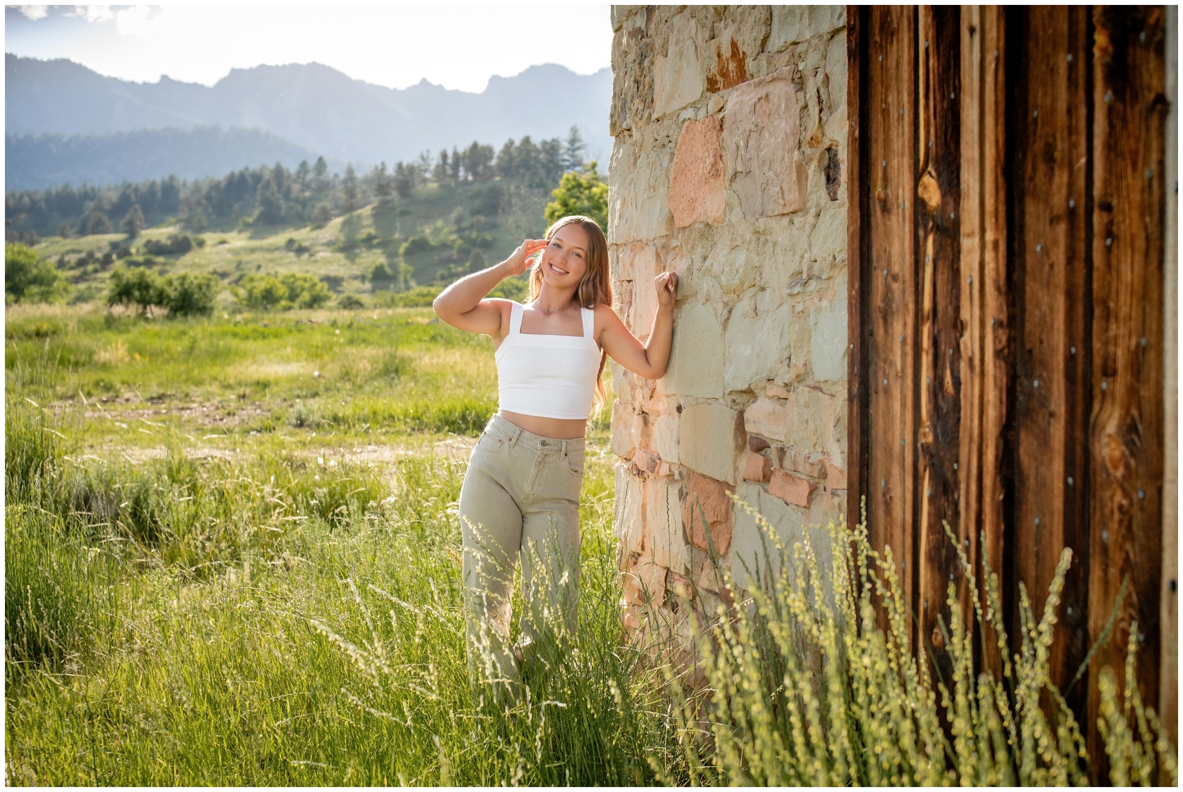 teen leaning against old stone building during Boulder Colorado mountain senior portraits