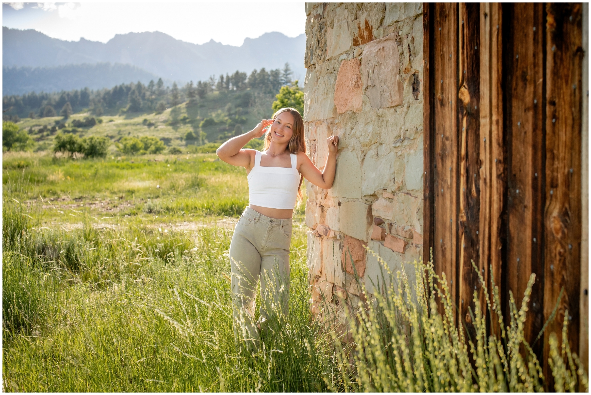 teen leaning against old stone building during Boulder Colorado mountain senior portraits 