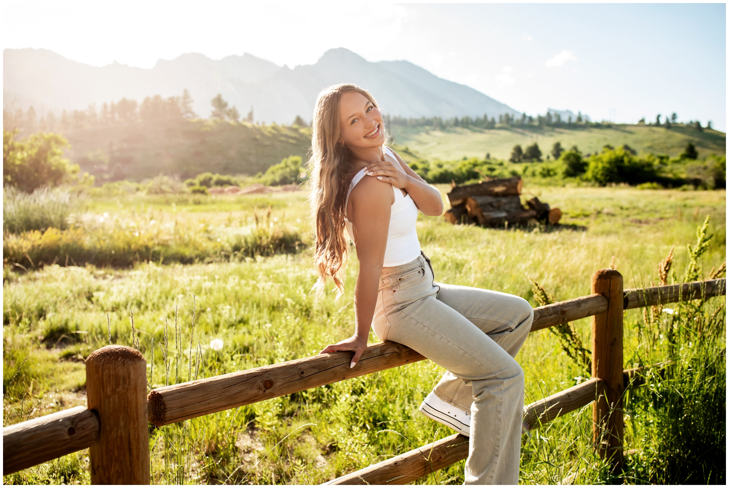 teen sitting on wooden fence during Boulder Colorado senior photography session by Plum Pretty Photography 