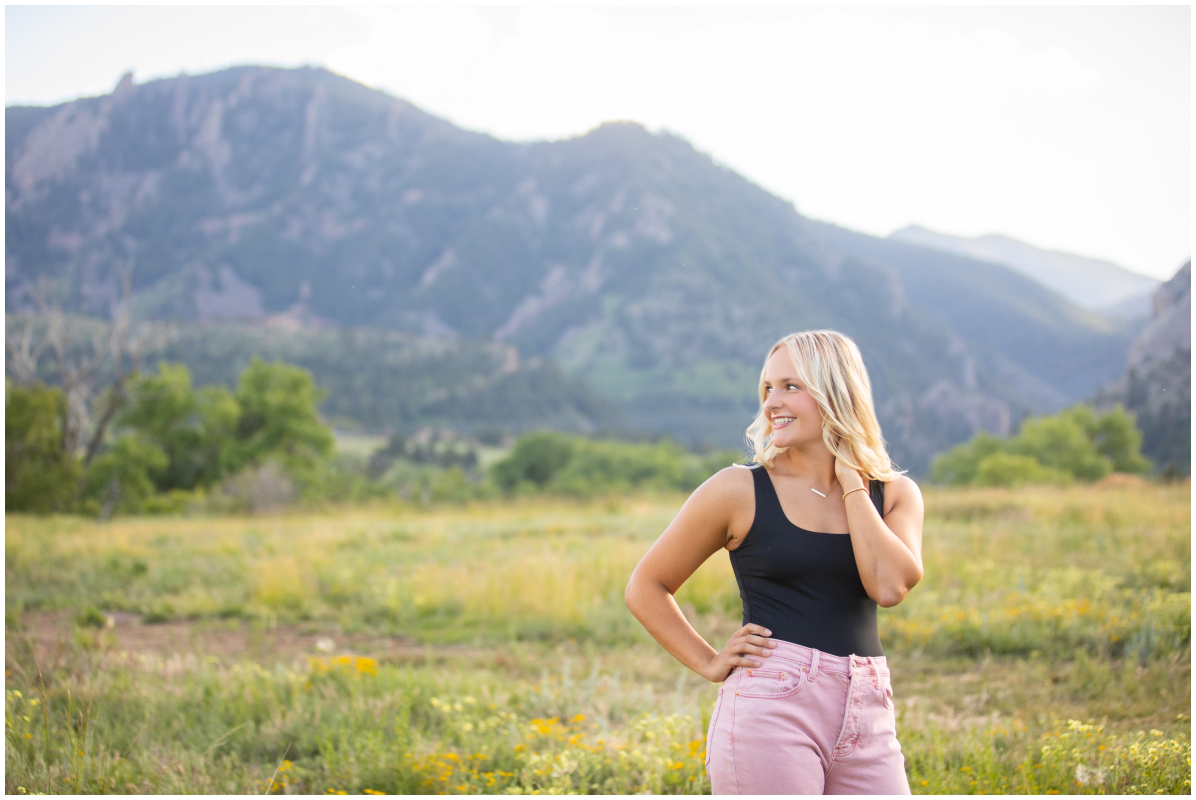 teen posing in a field during Colorado senior photos in the mountains 