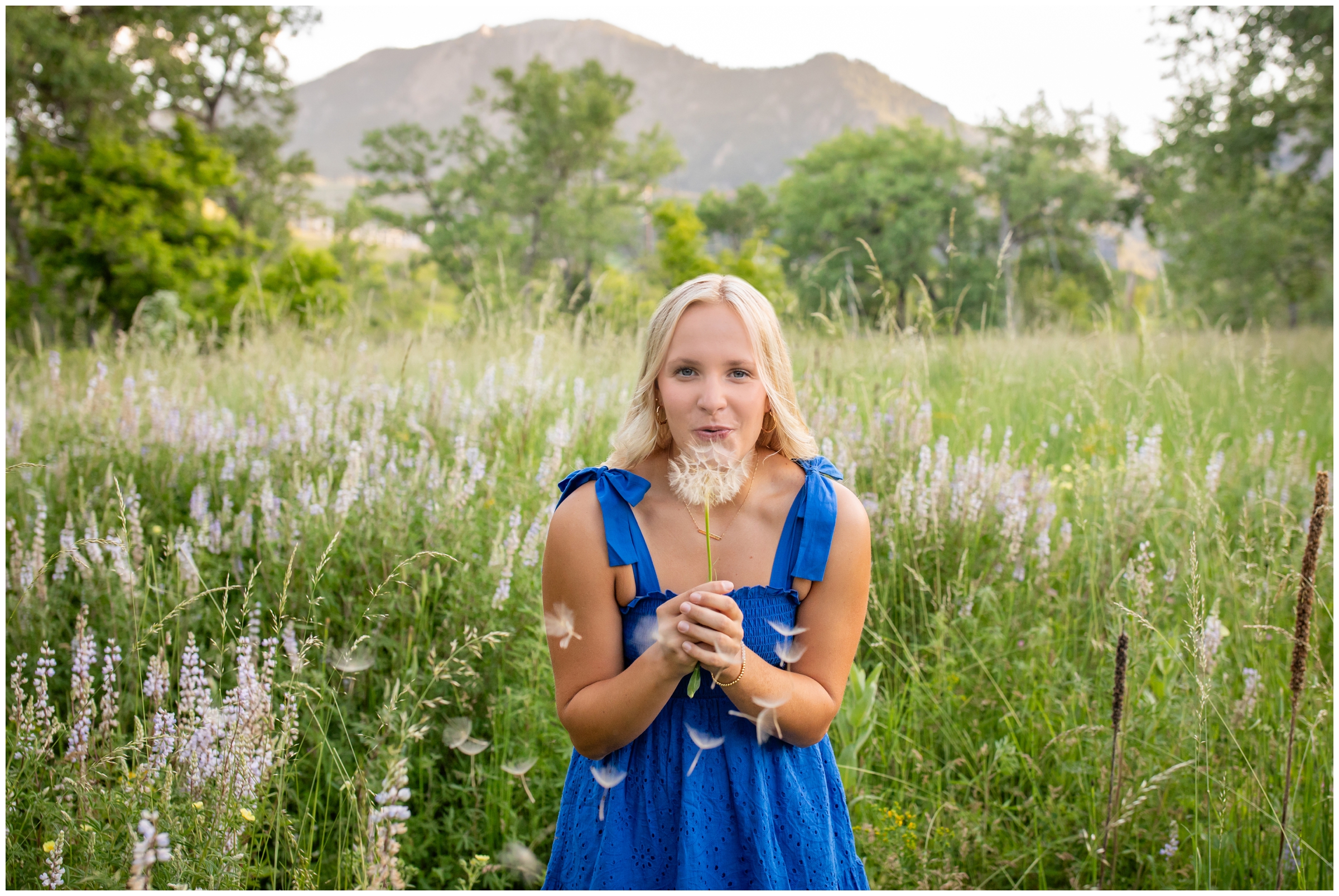 teen holding a dandelion during Colorado senior graduation portraits at South Mesa Trail in Boulder