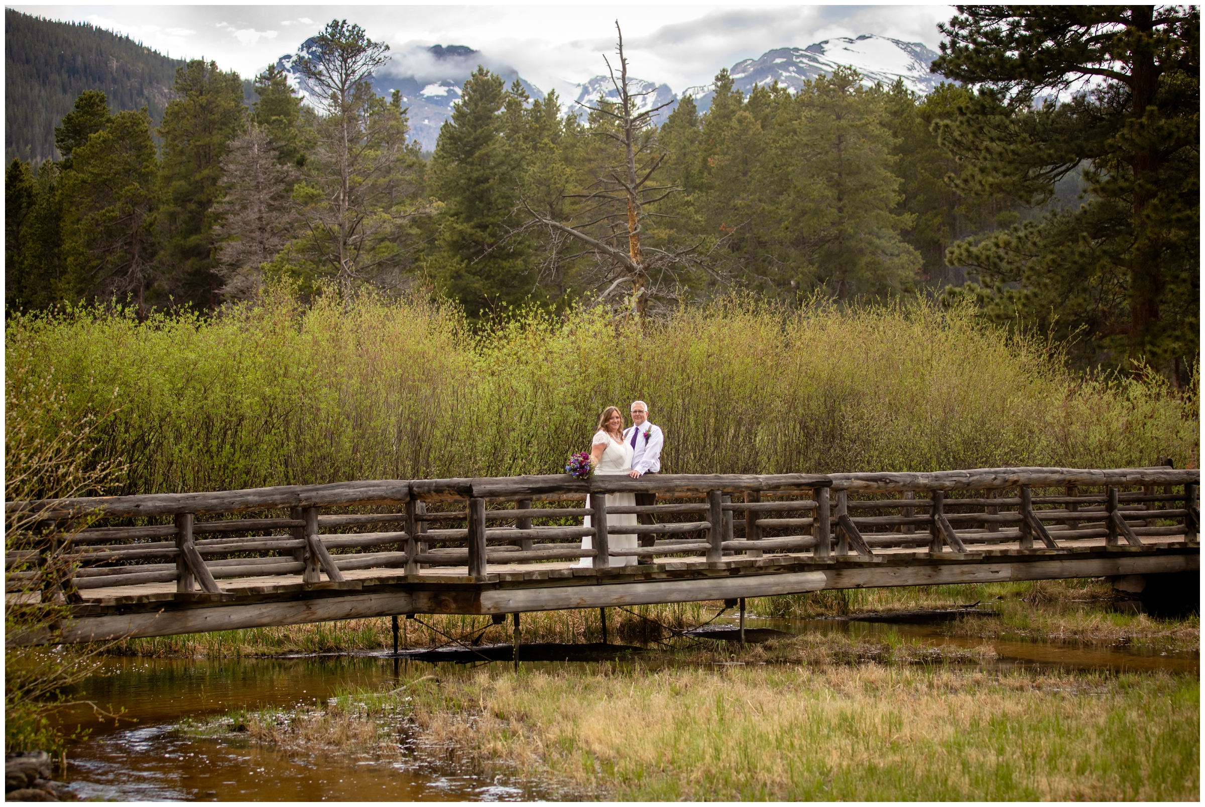 couple posing on wooden bridge at Sprague Lake in Estes Park 