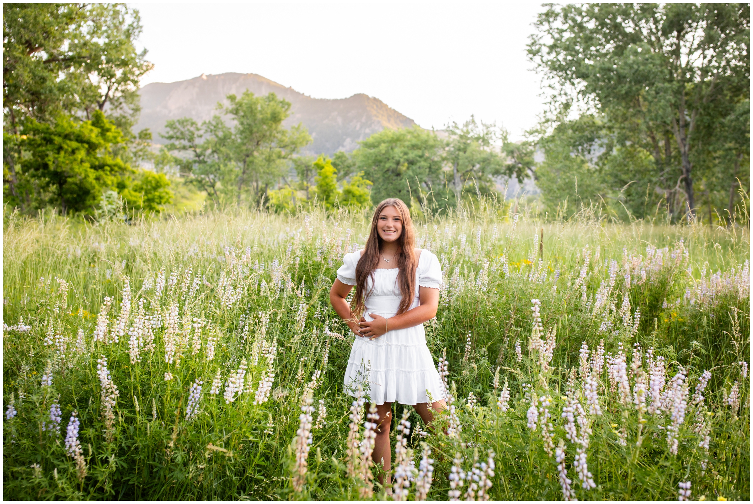 teen posing in field of wildflowers in the Colorado mountains at South Mesa Trail