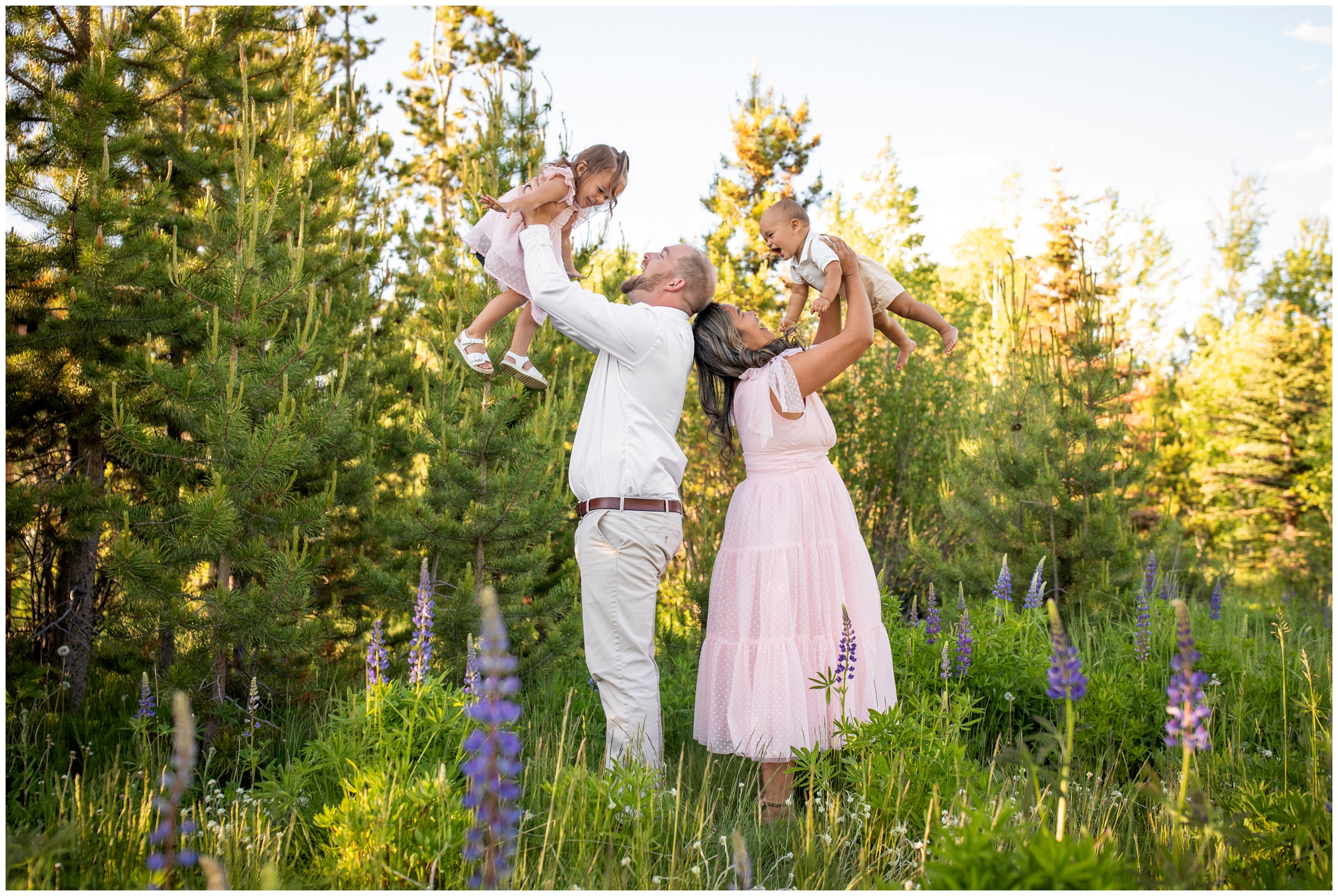 parents lifting kids in the air during candid photography session in Grand lake Colorado 