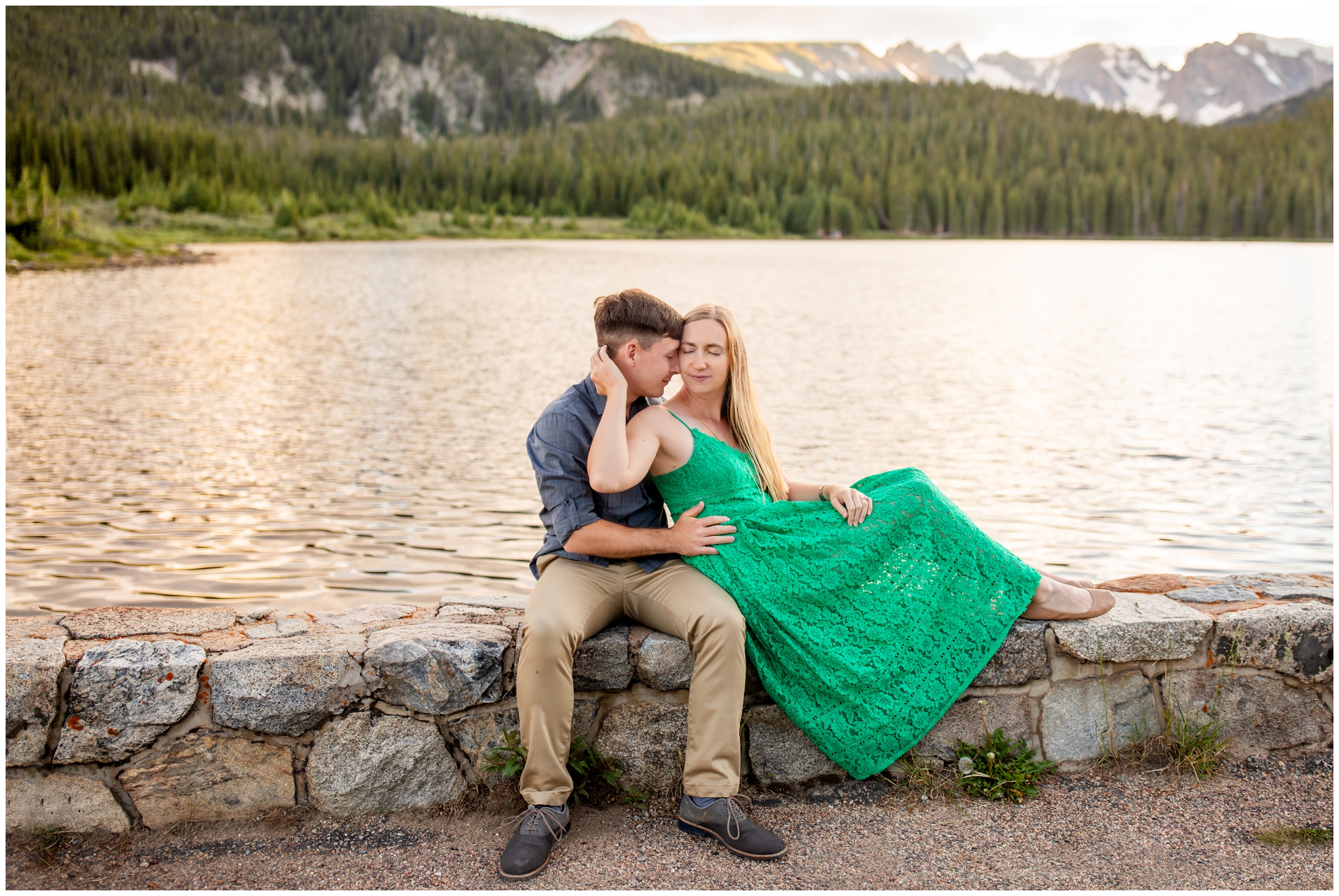 couple posing next to a Colorado mountain lake at sunset during Estes Park engagement pictures 