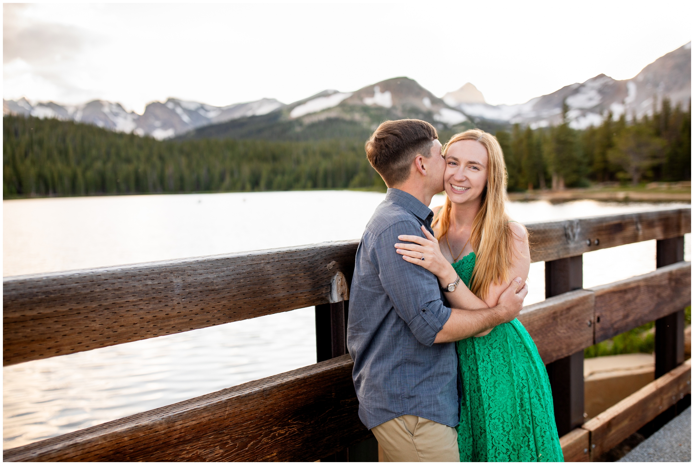 couple embracing on a wooden bridge during Estes Park engagement pictures by Plum Pretty Photography 
