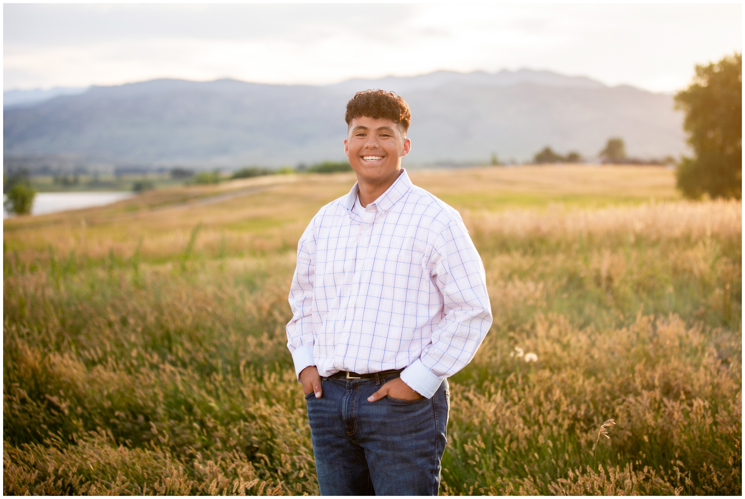 teen guy posing in a mountain field during Boulder senior photos at Coot Lake 