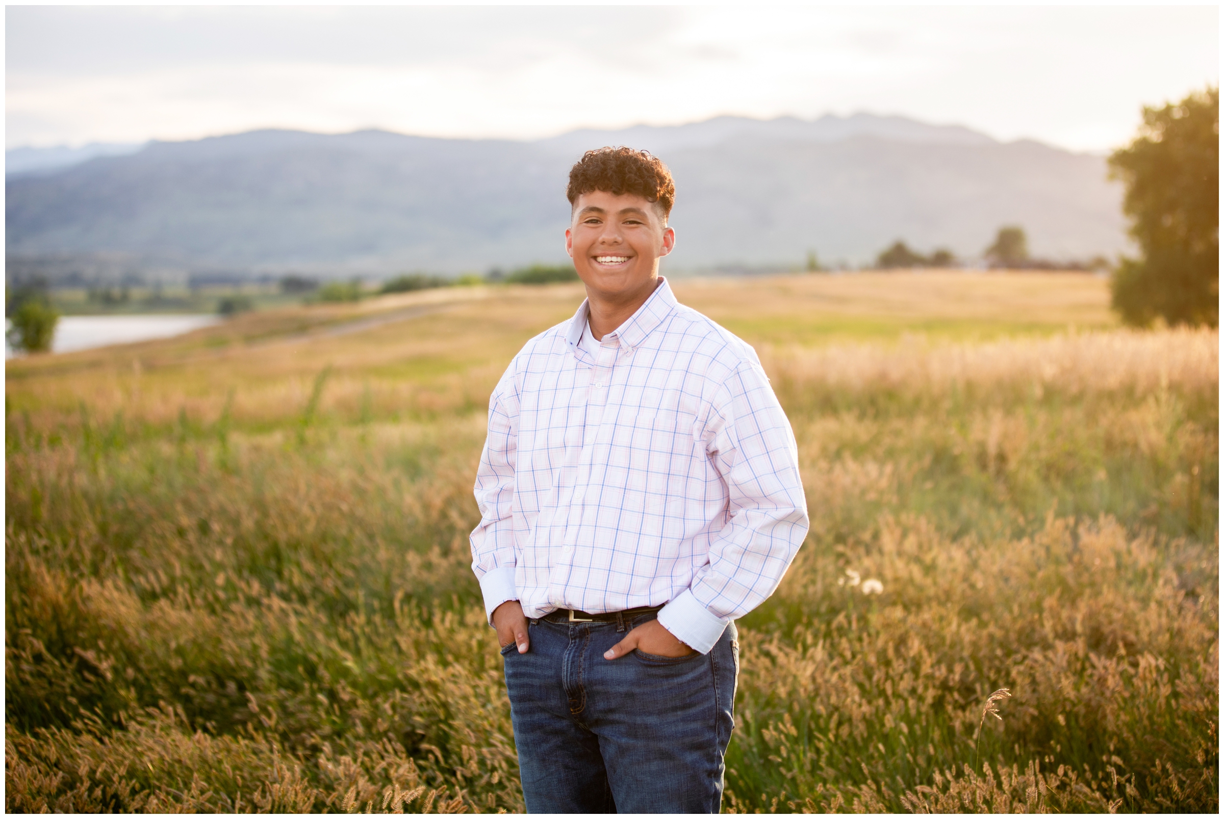 teen guy posing in a mountain field during Boulder senior photos at Coot Lake