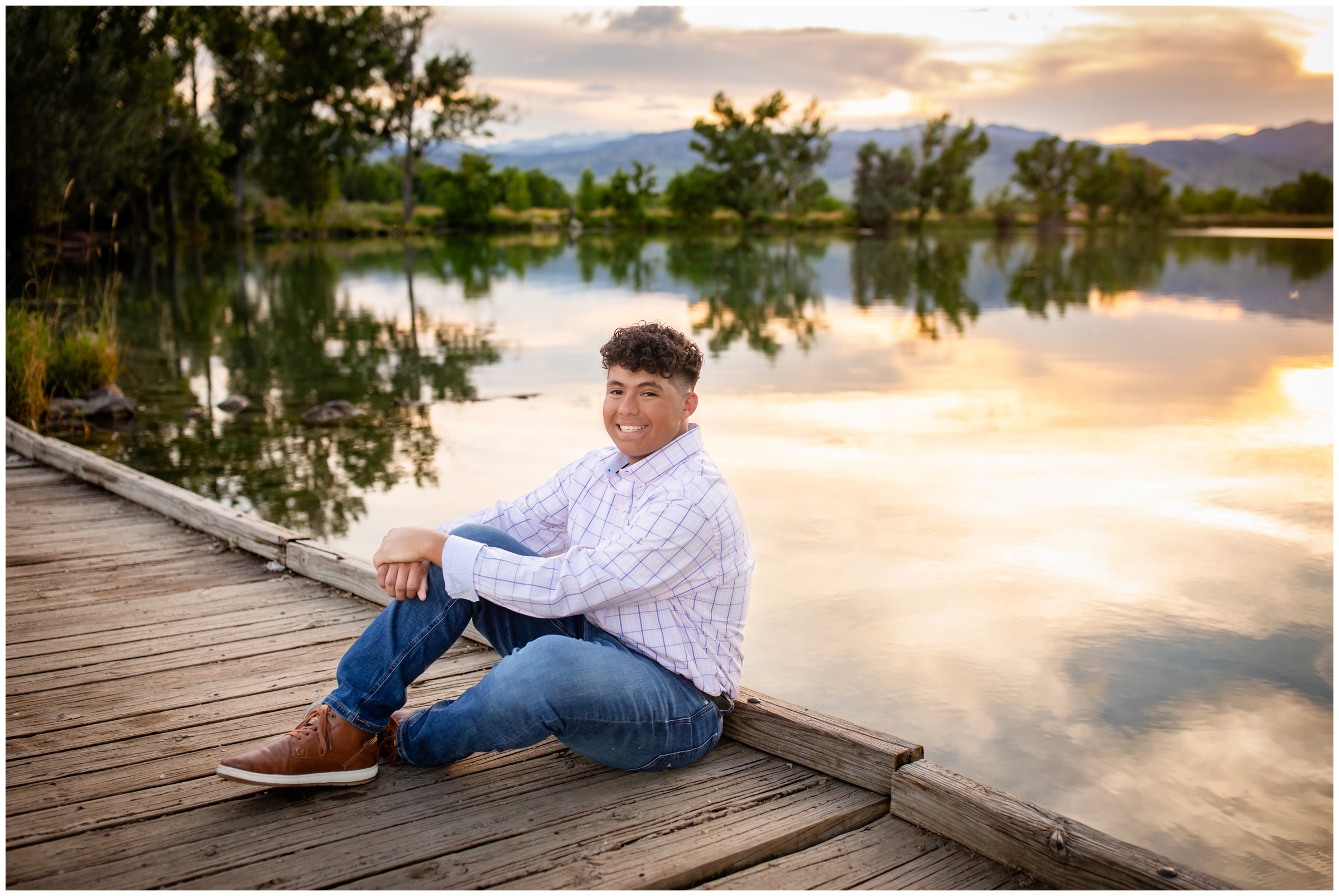 teen guy posing on a bridge during sunset senior photos at Coot Lake in Boulder Colorado 