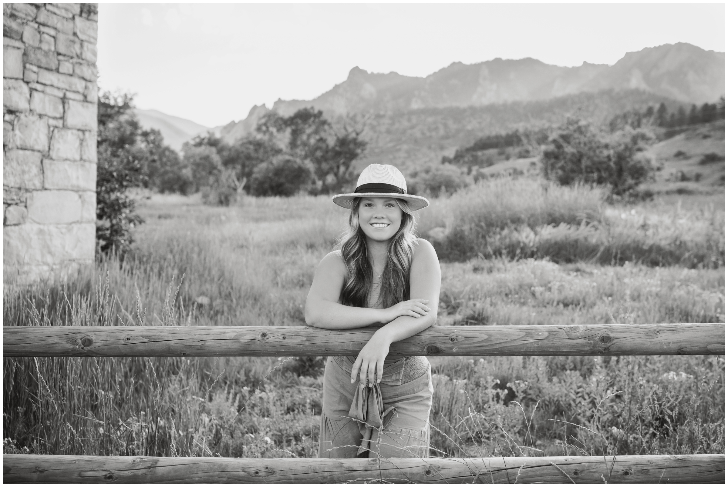 teen leaning on fence during Boulder senior pictures by Plum Pretty Photography 