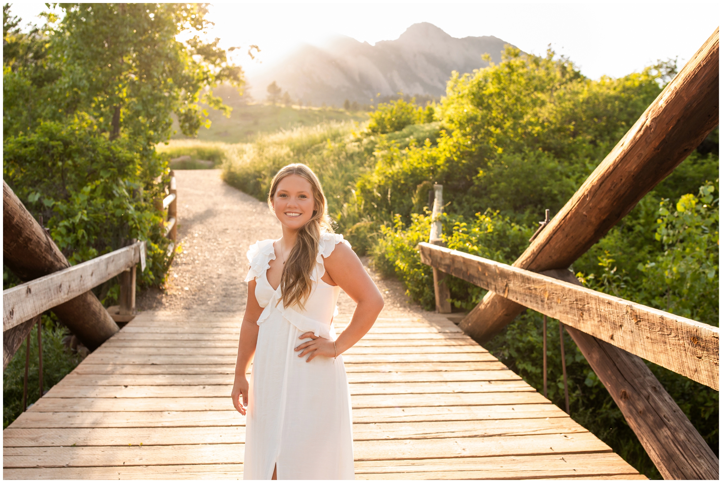 teen posing on wooden bridge during summer senior portraits in Boulder Colorado 