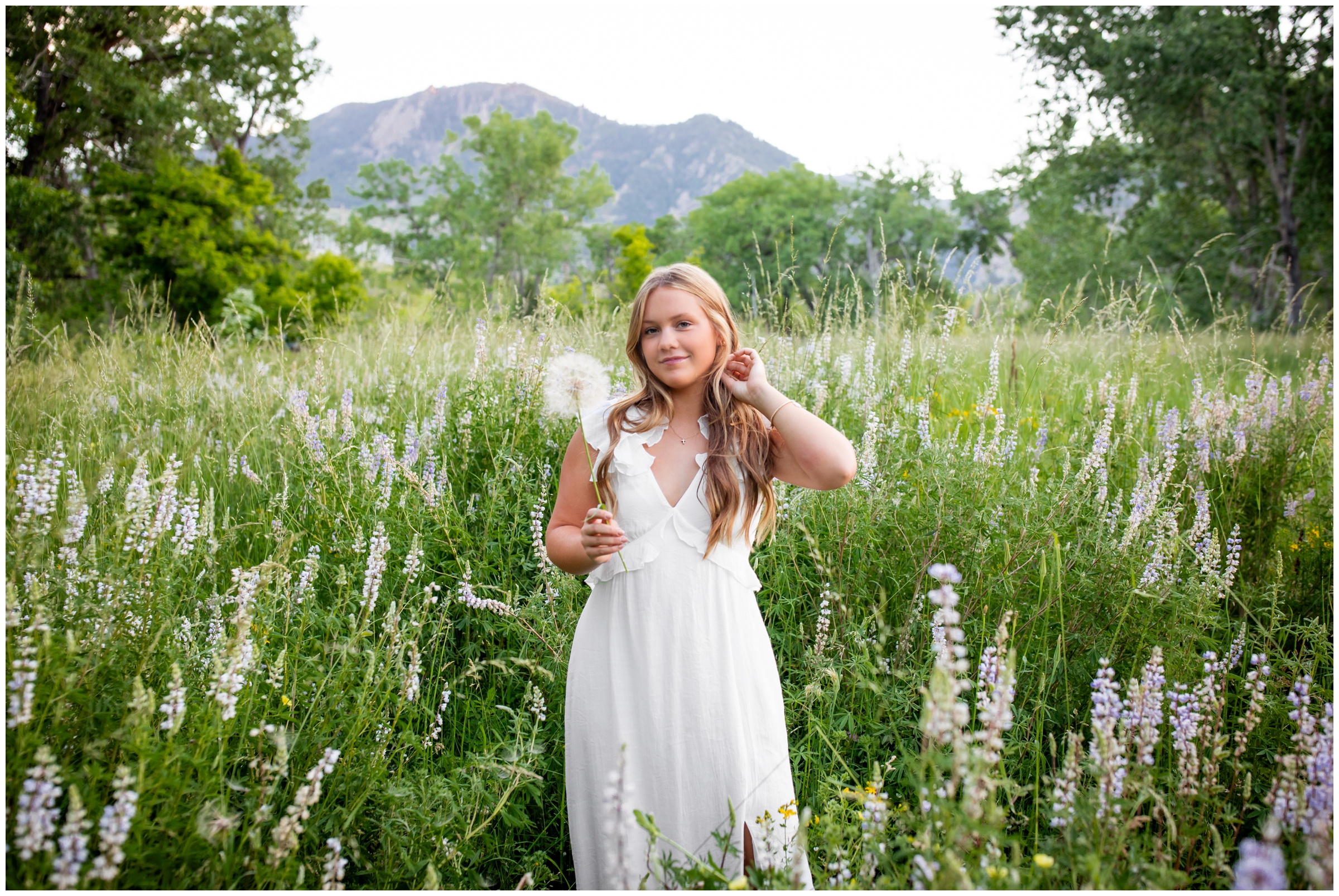 teen holding dandelion during unique graduation photography session in Boulder by Plum Pretty Photography 