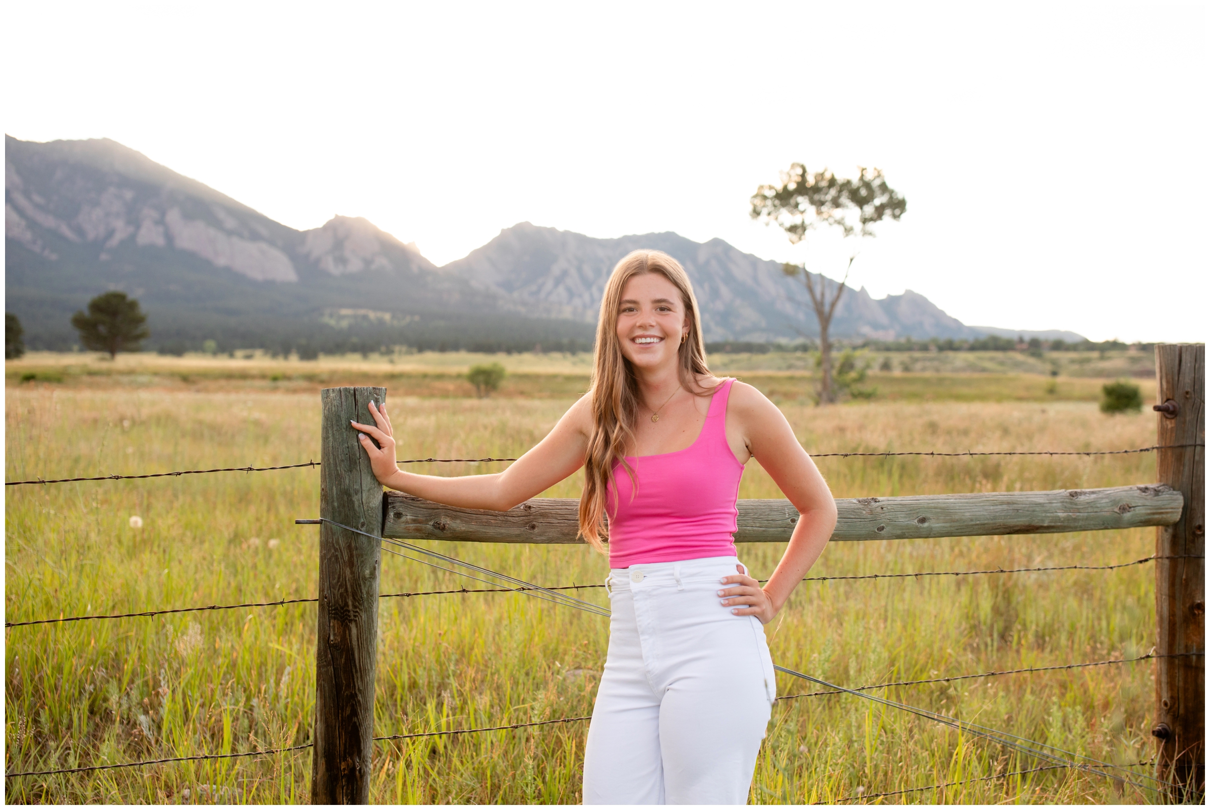 teen leaning against fence during Colorado mountain senior portraits by Plum Pretty Photography 
