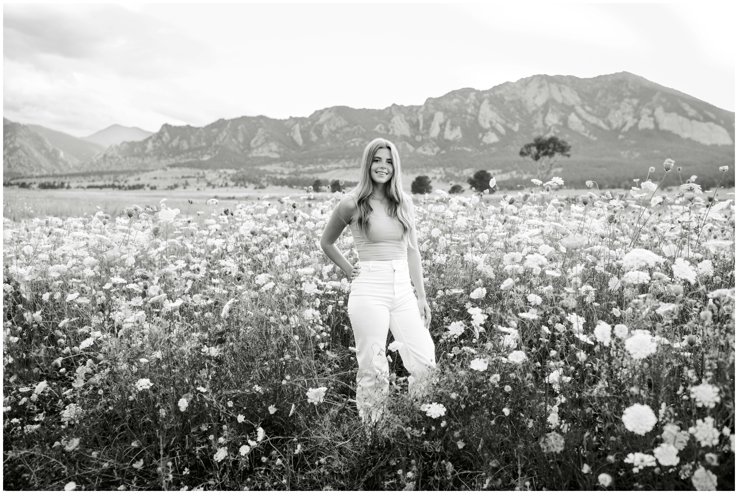 teen posing in field of mountain wild flowers during Boulder Colorado senior pictures by Plum Pretty Photography 