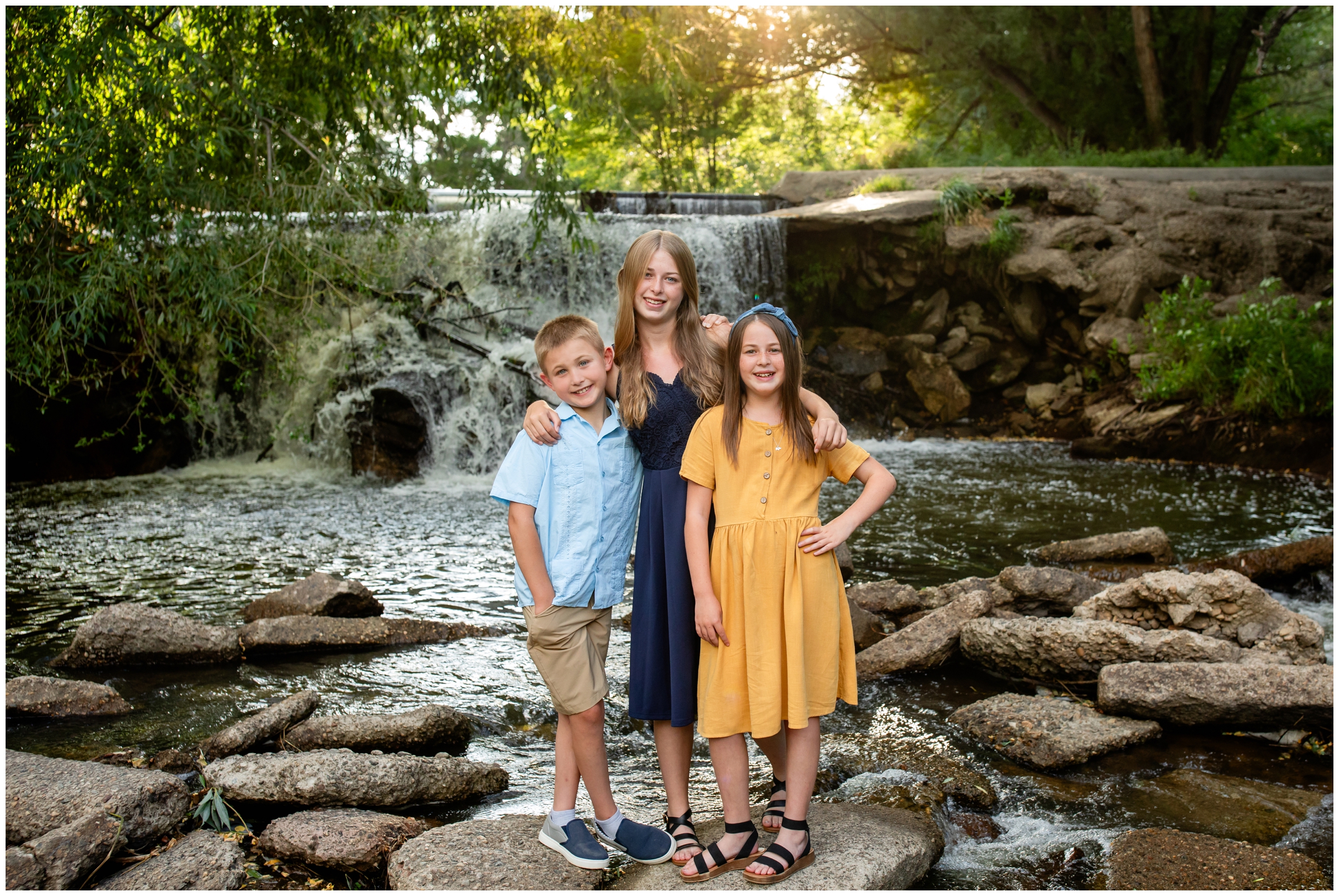 kids posing in front of waterfall during Golden Ponds longmont Colorado family photography session 