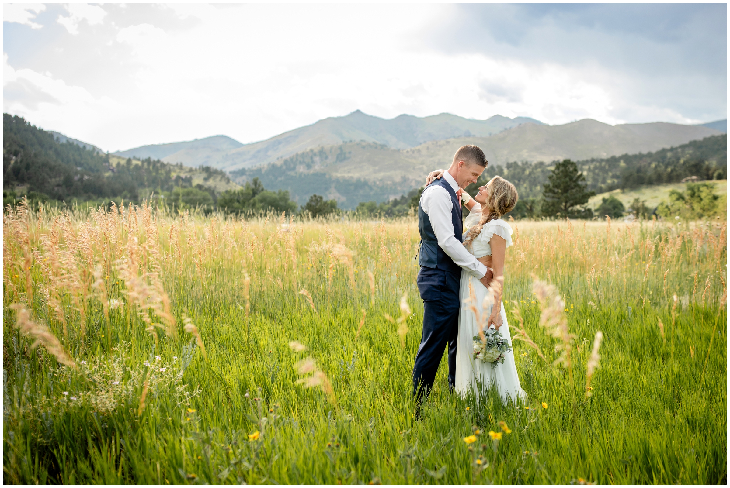 couple embracing in a mountain field during Greenbriar Inn wedding photography in Boulder Colorado