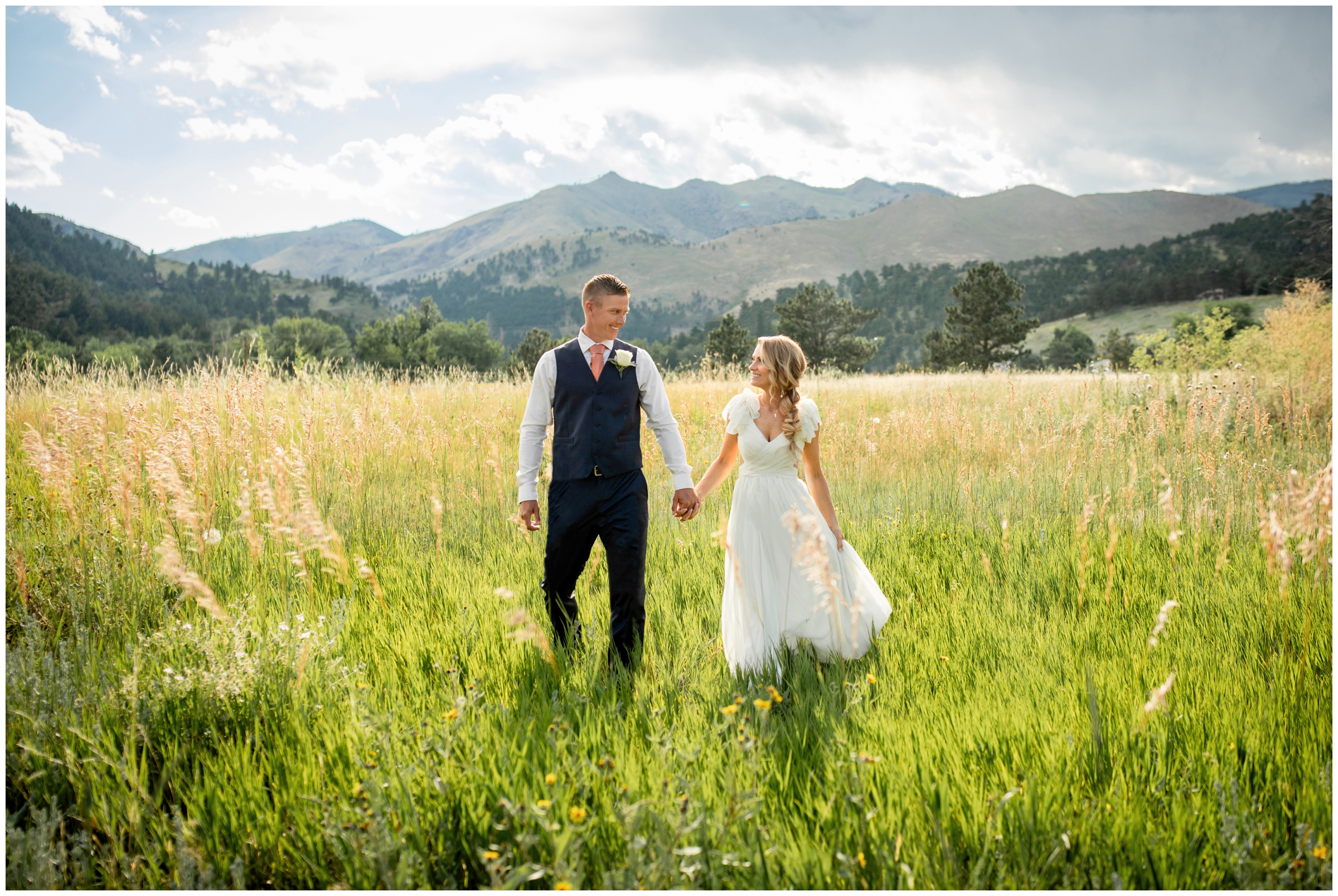 couple walking in a field behind the Greenbriar Inn during Boulder mountain wedding pictures 