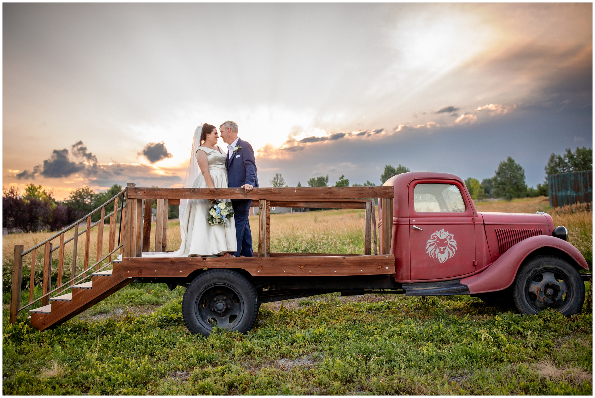 couple posing on vintage truck during Colorado Lionsgate Event Center summer wedding photos