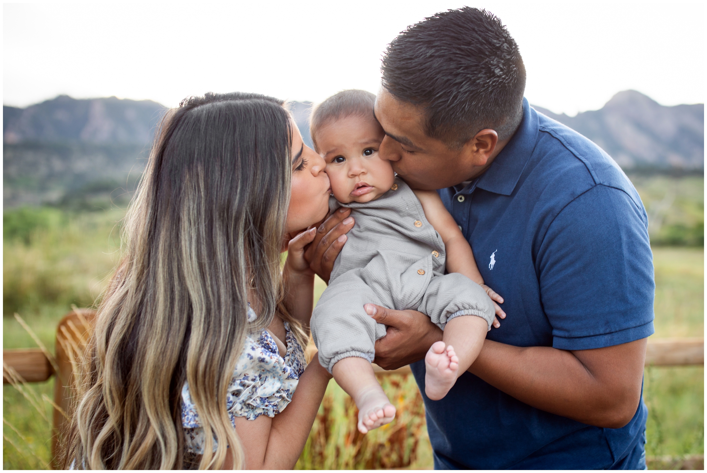 parents kissing baby's cheeks during family pictures at south mesa in Boulder Colorado 