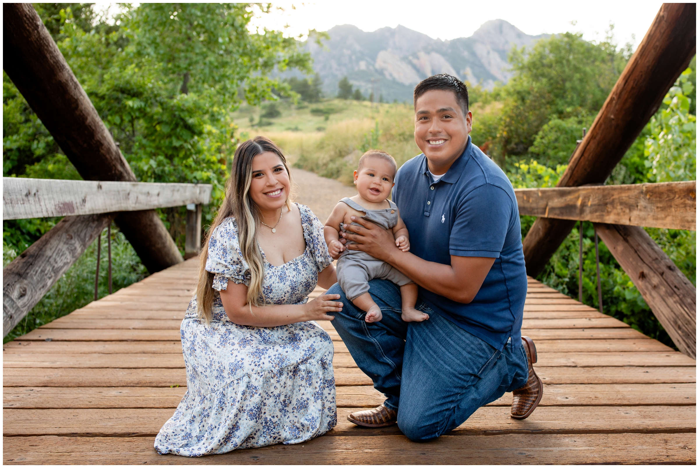 family posing on wooden bridge during Boulder Colorado family portraits by Plum Pretty Photography