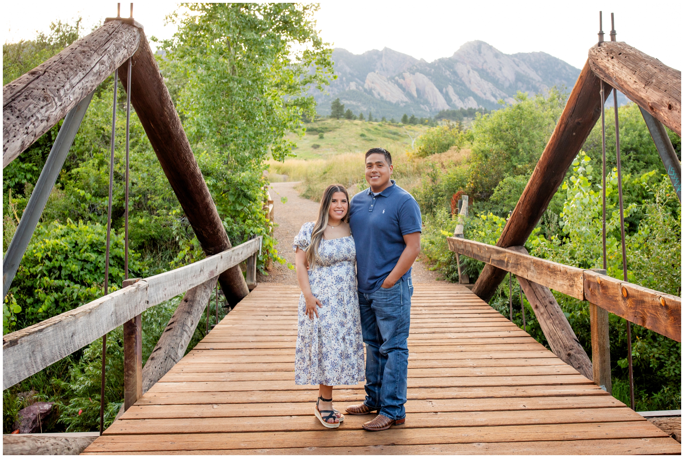 couple posing on wooden bridge during Colorado couples photography session at South Mesa Trail