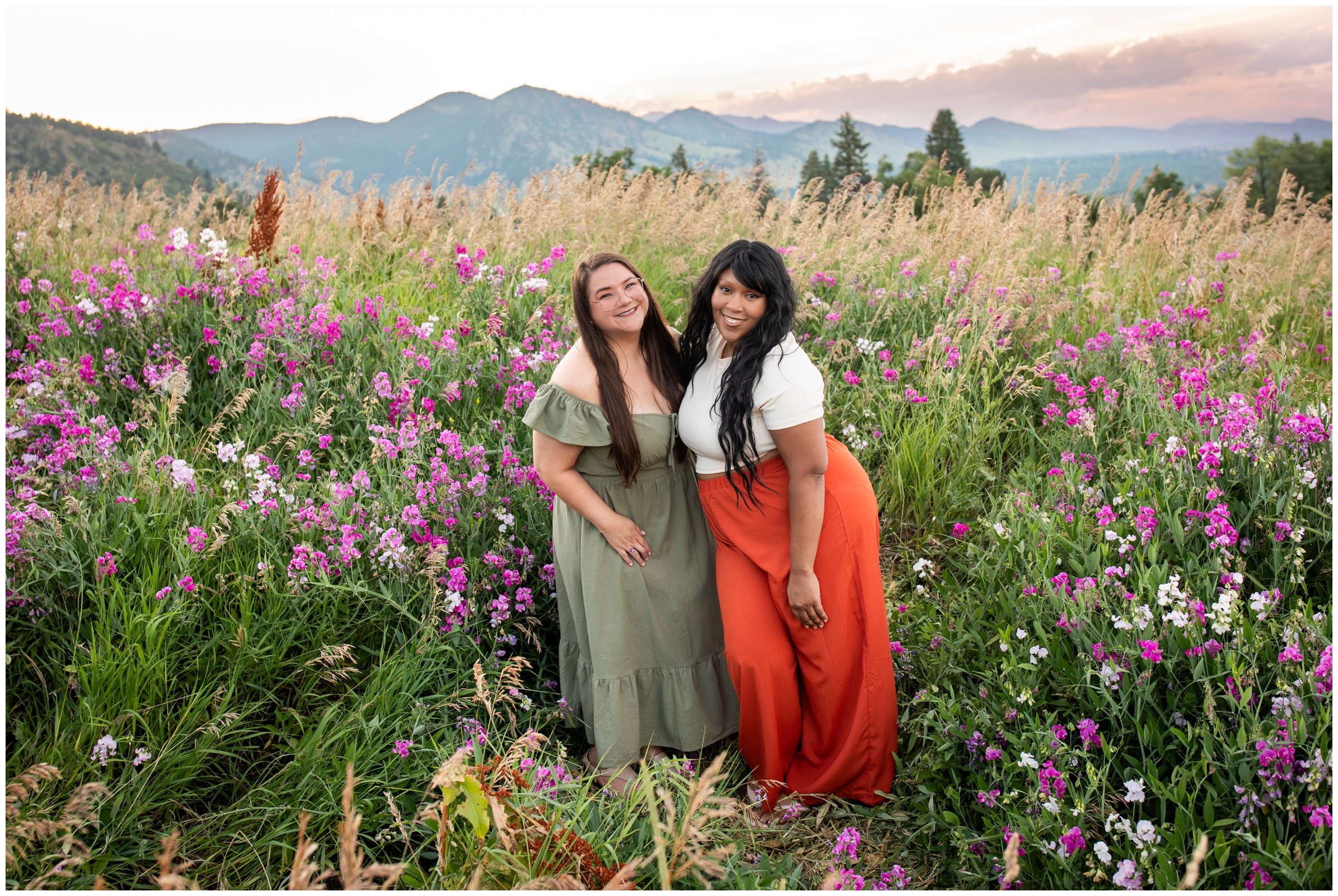 two women posing in wild flower field during Boulder Colorado best friends portraits