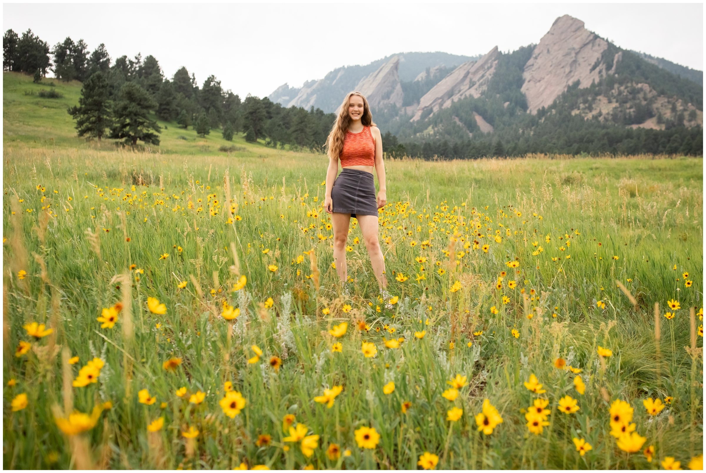 teen posing in wildflower field at Chautauqua during Boulder Colorado senior pictures by Plum Pretty Photo 